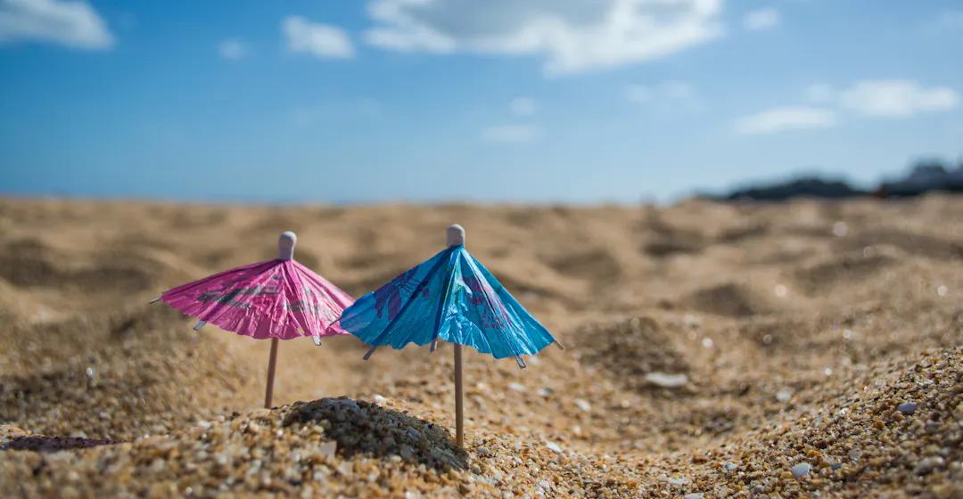 Two umbrellas in sand representing microlearning