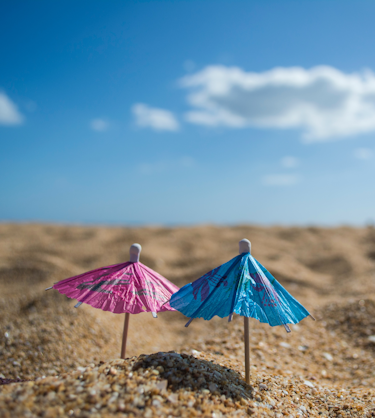 Two umbrellas in sand representing microlearning