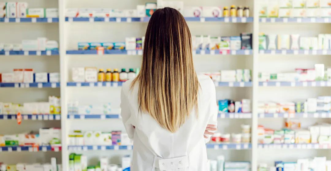 Woman in pharmacy meant to represent choosing a pharma lms