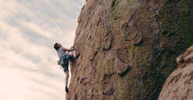 rock climber representing company scaling