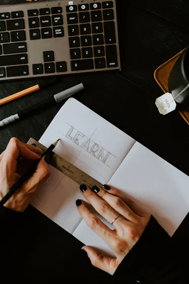 woman writing the word learn representing the customer onboarding process