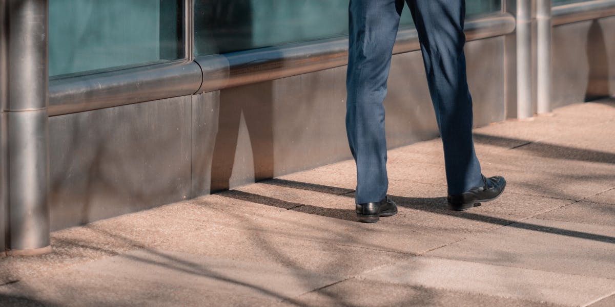 Sales person walking away, close up on legs