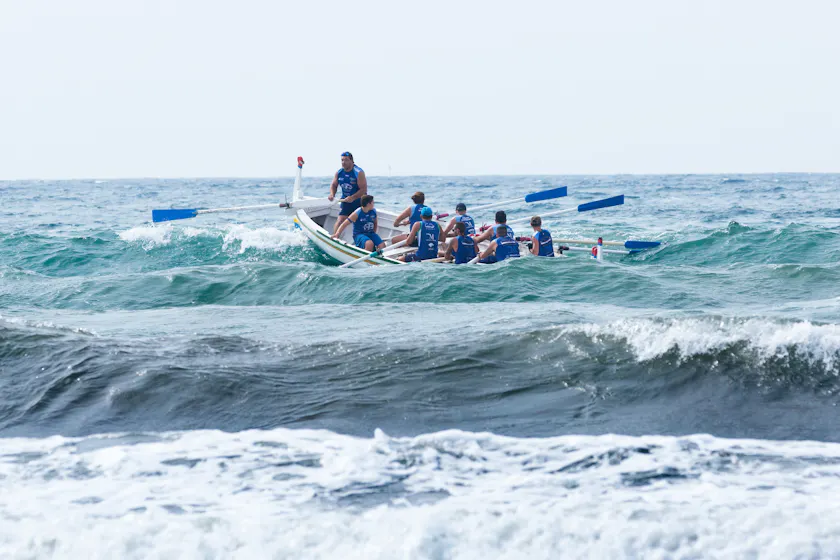 Men in boat representing management coaching