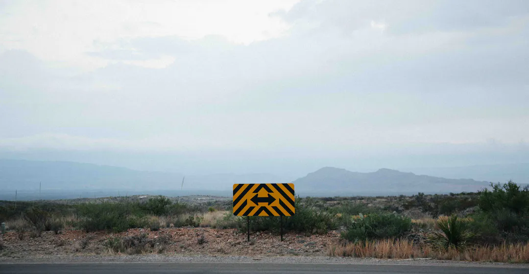 Photo of a sign with two arrow representing how to choose the best customer training software for your business