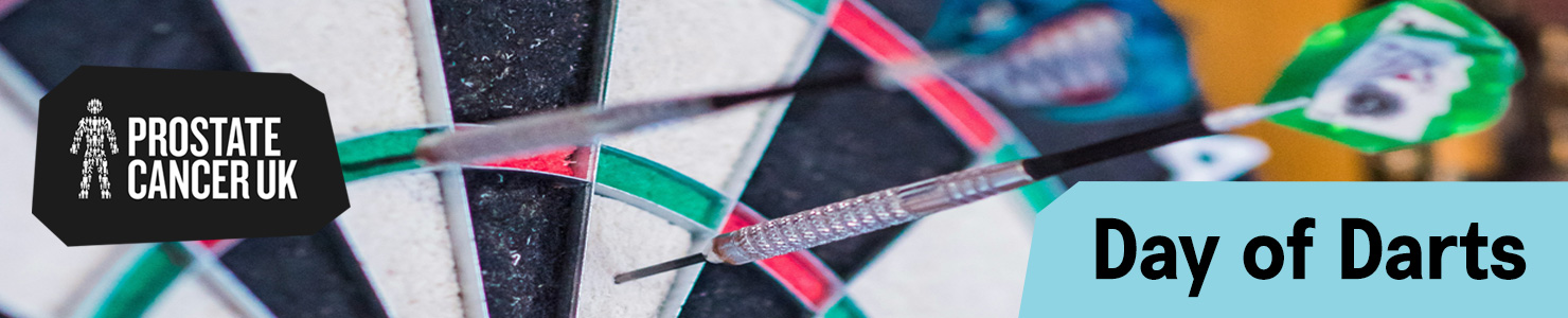 Darts embedded in a dartboard promoting Prostate Cancer UK’s Day of Darts challenge.