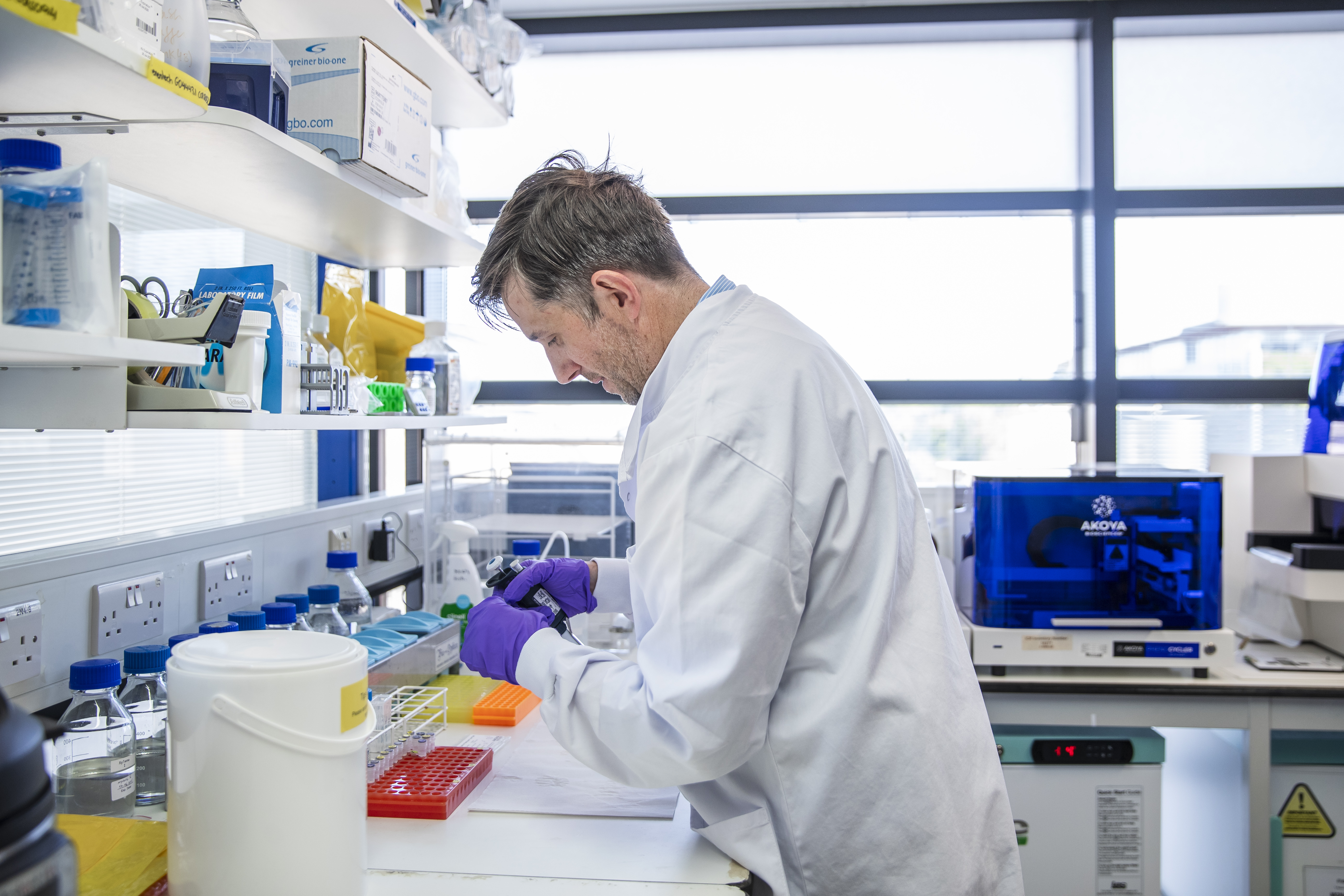 Researcher using a pipette to prepare samples in a laboratory.