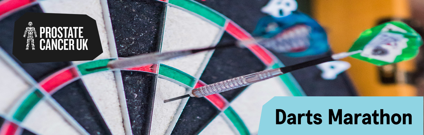 Darts embedded in a dartboard promoting Prostate Cancer UK’s Darts Marathon challenge.