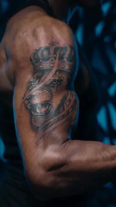Crowned lion artwork on an upper arm