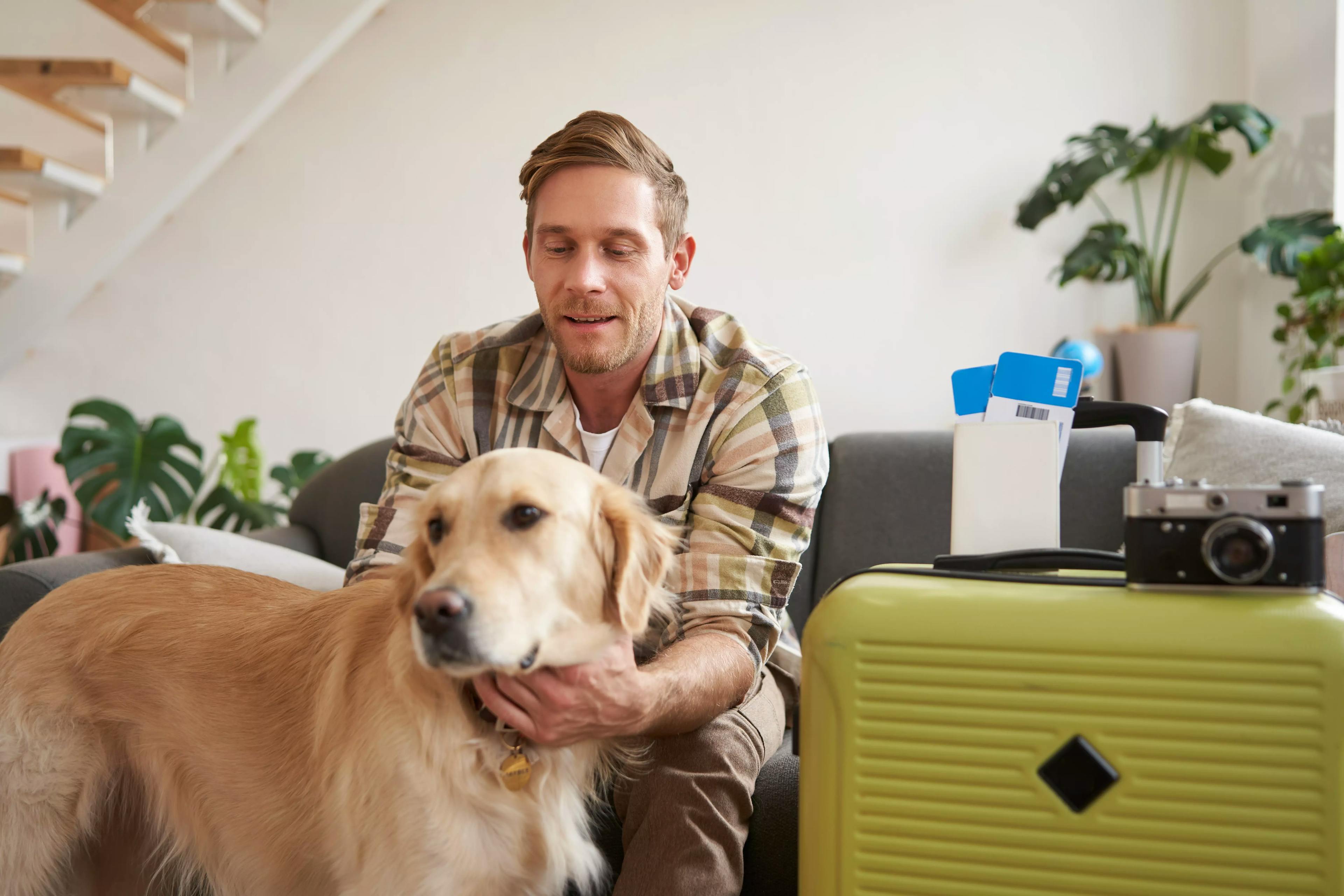 чоловік прощається із своєю собакою перед тим як поїхати у відпустку