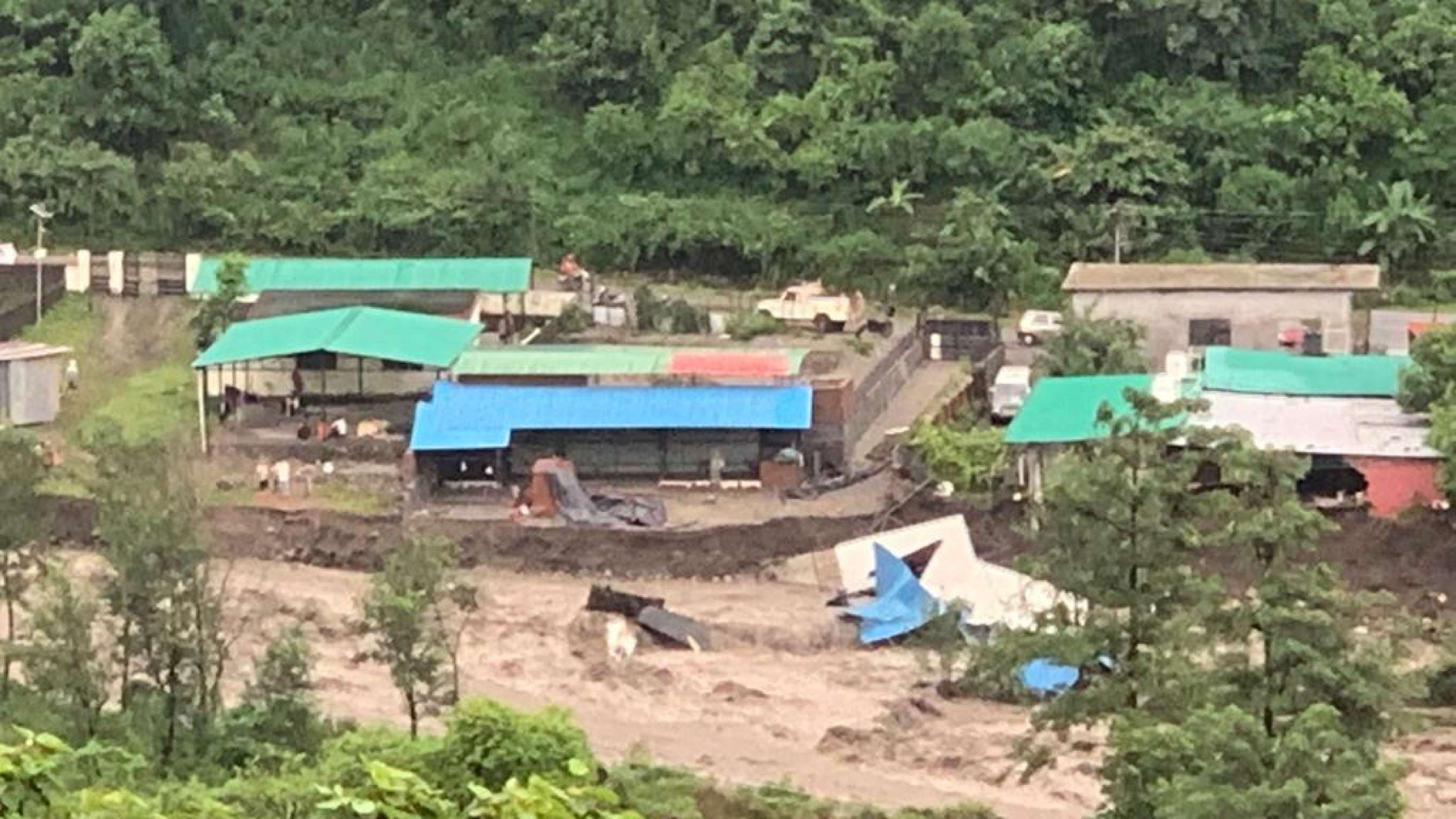 View of the Lama Tenzin flood, buildings and rushing water
