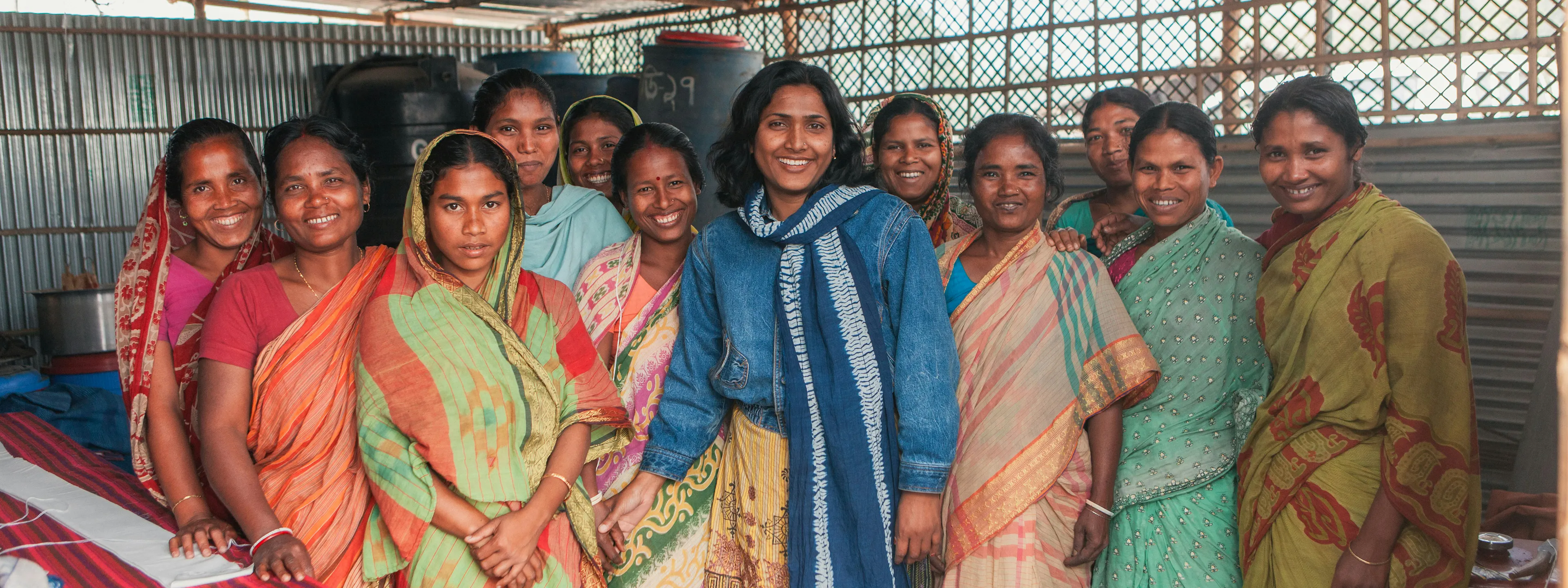 Women standing together at a community programme