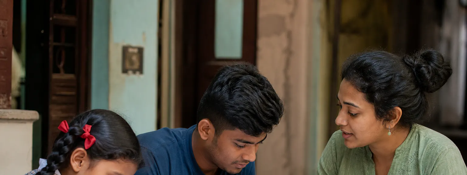 Students receiving educational guidance at a community learning table