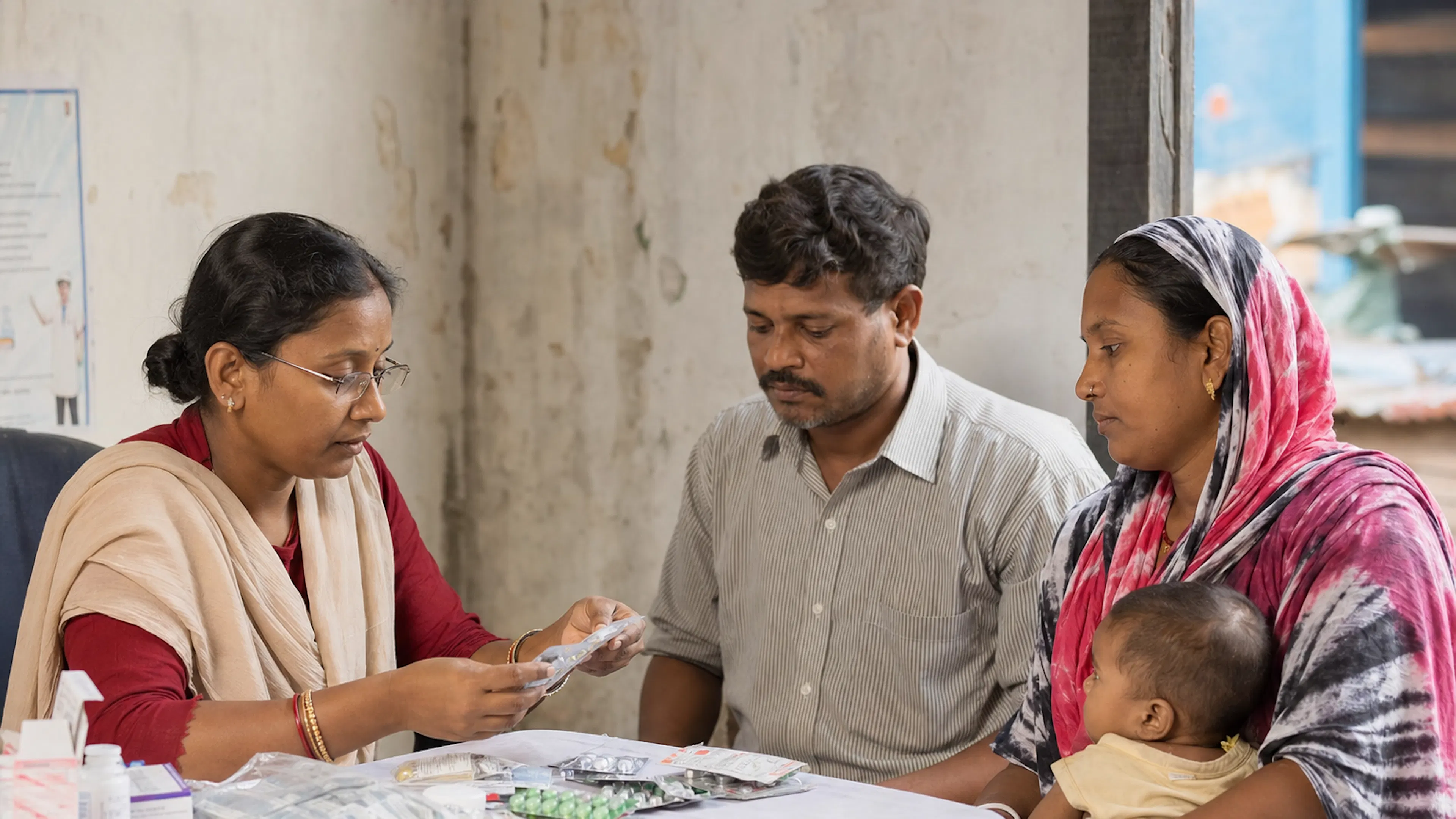 A community health worker providing medicine support to a family