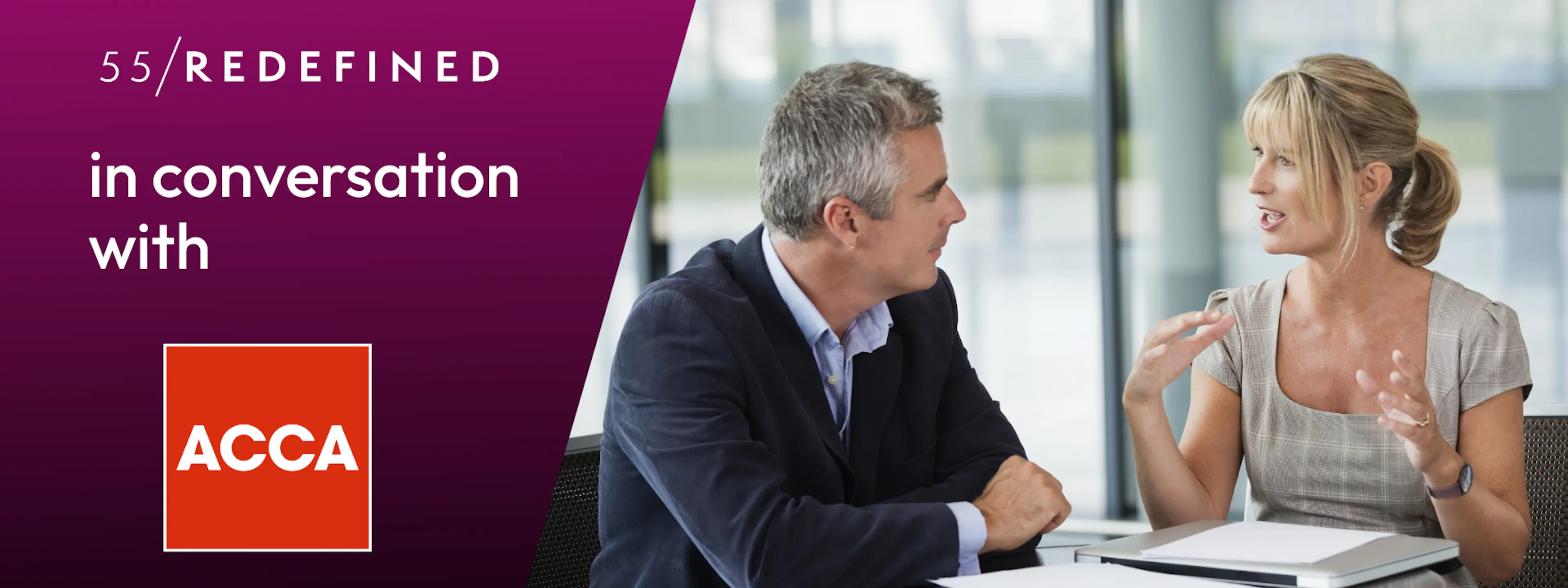 Two midlife business people are talking animatedly at a table.