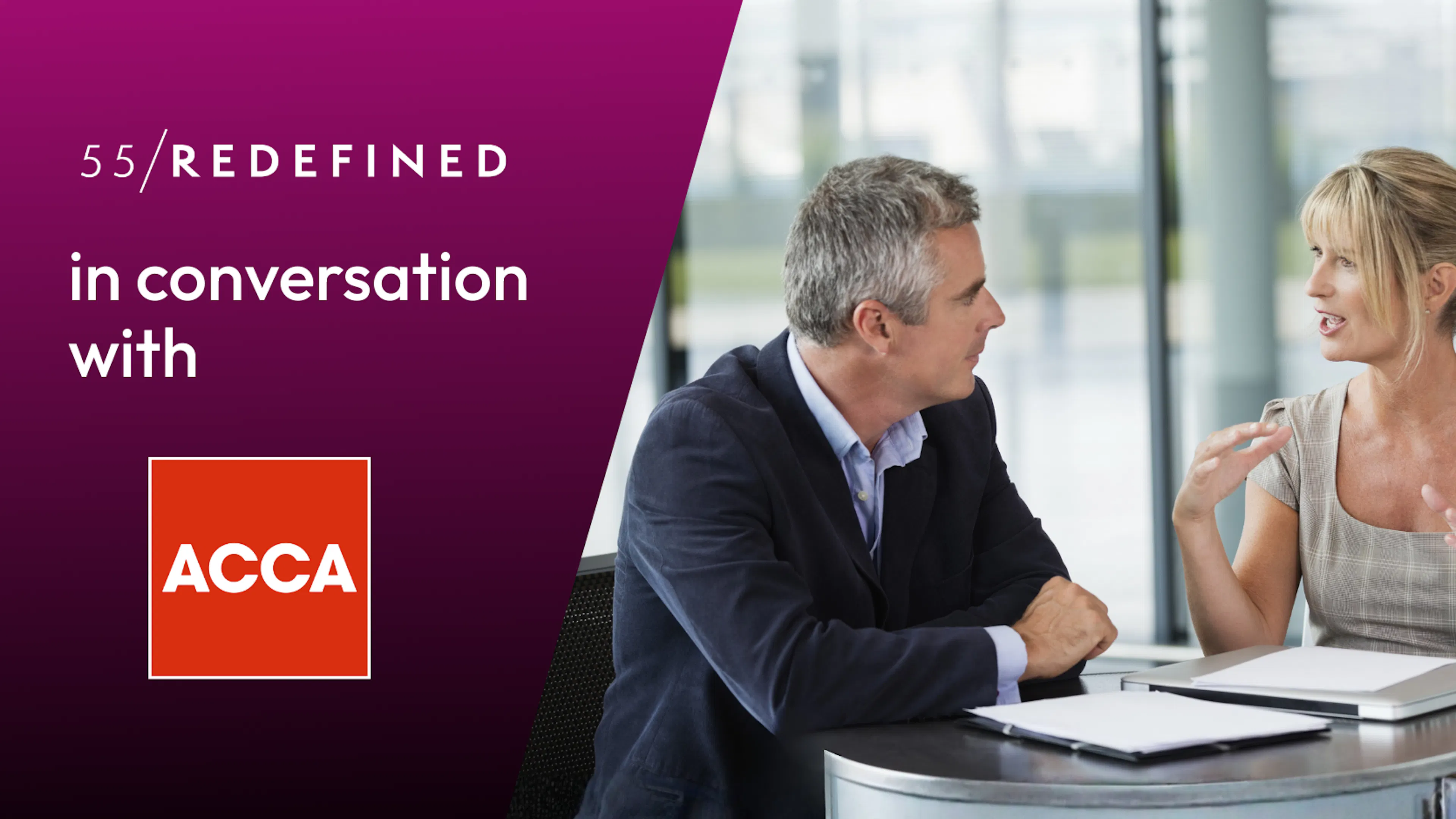 Two midlife business people are talking animatedly at a table.