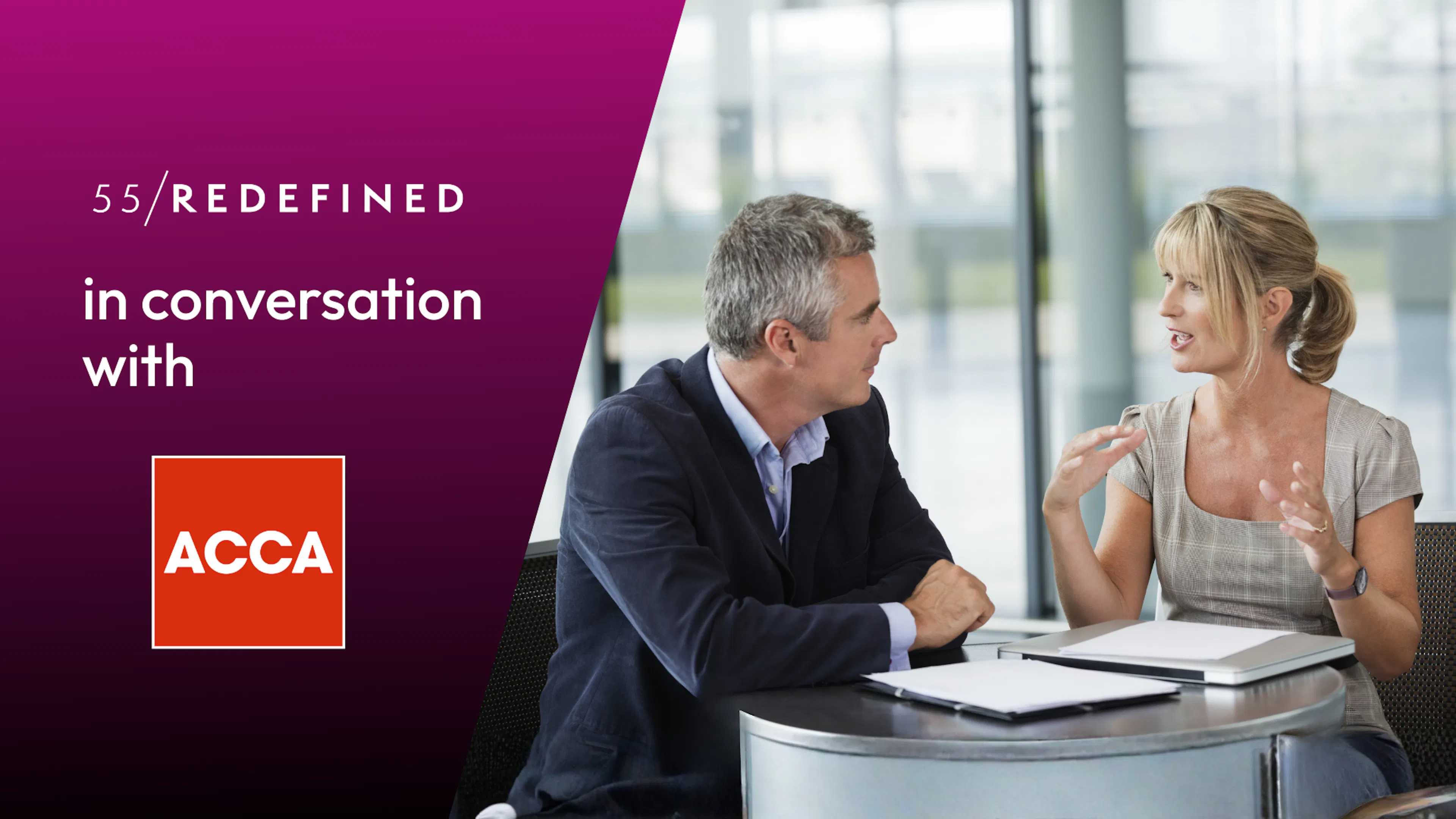 Two midlife business people are talking animatedly at a table.