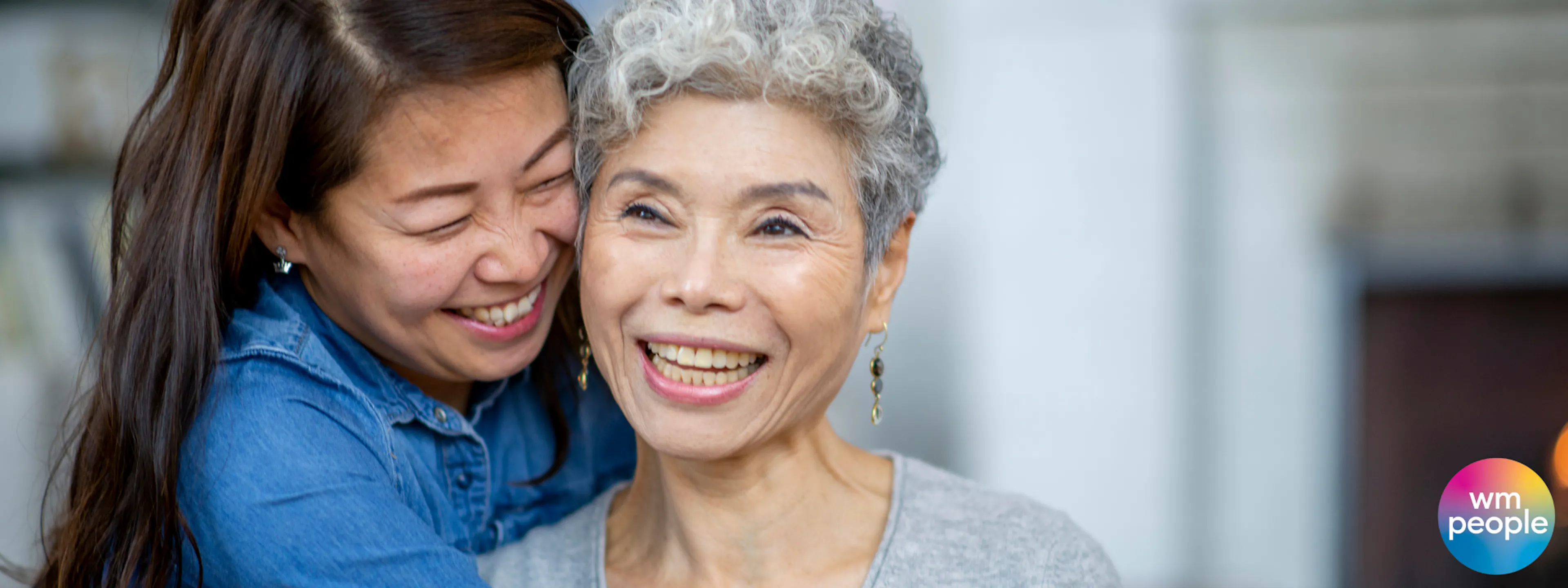 Older daughter hugging her mother