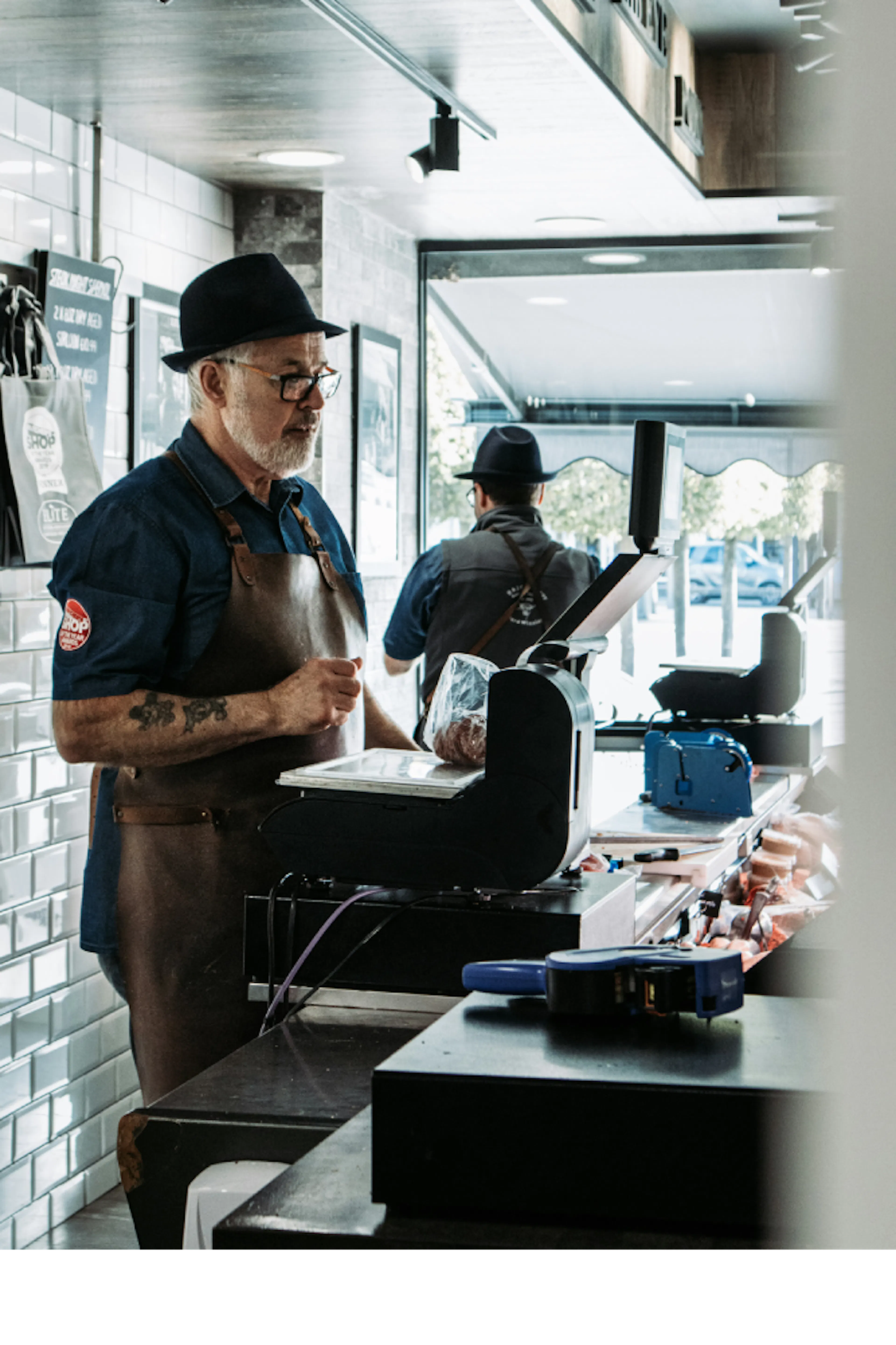 A man weighs items at the checkout.