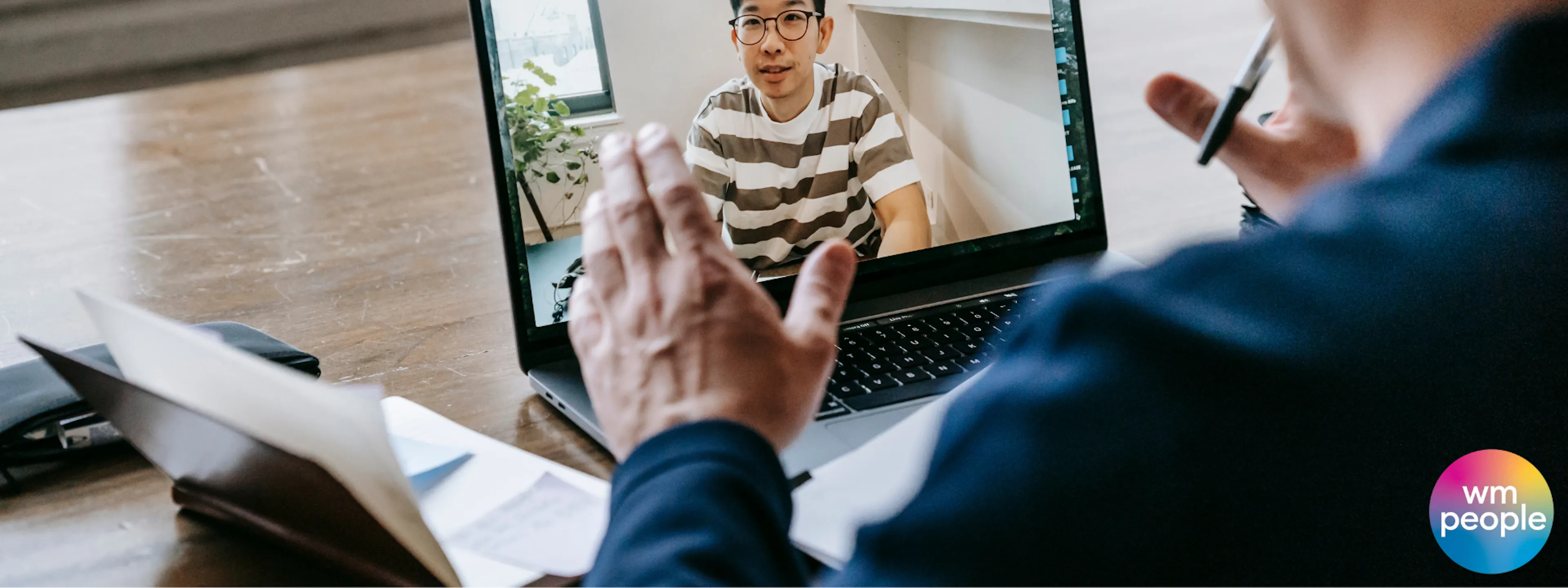 Older male talking to younger male via a screen