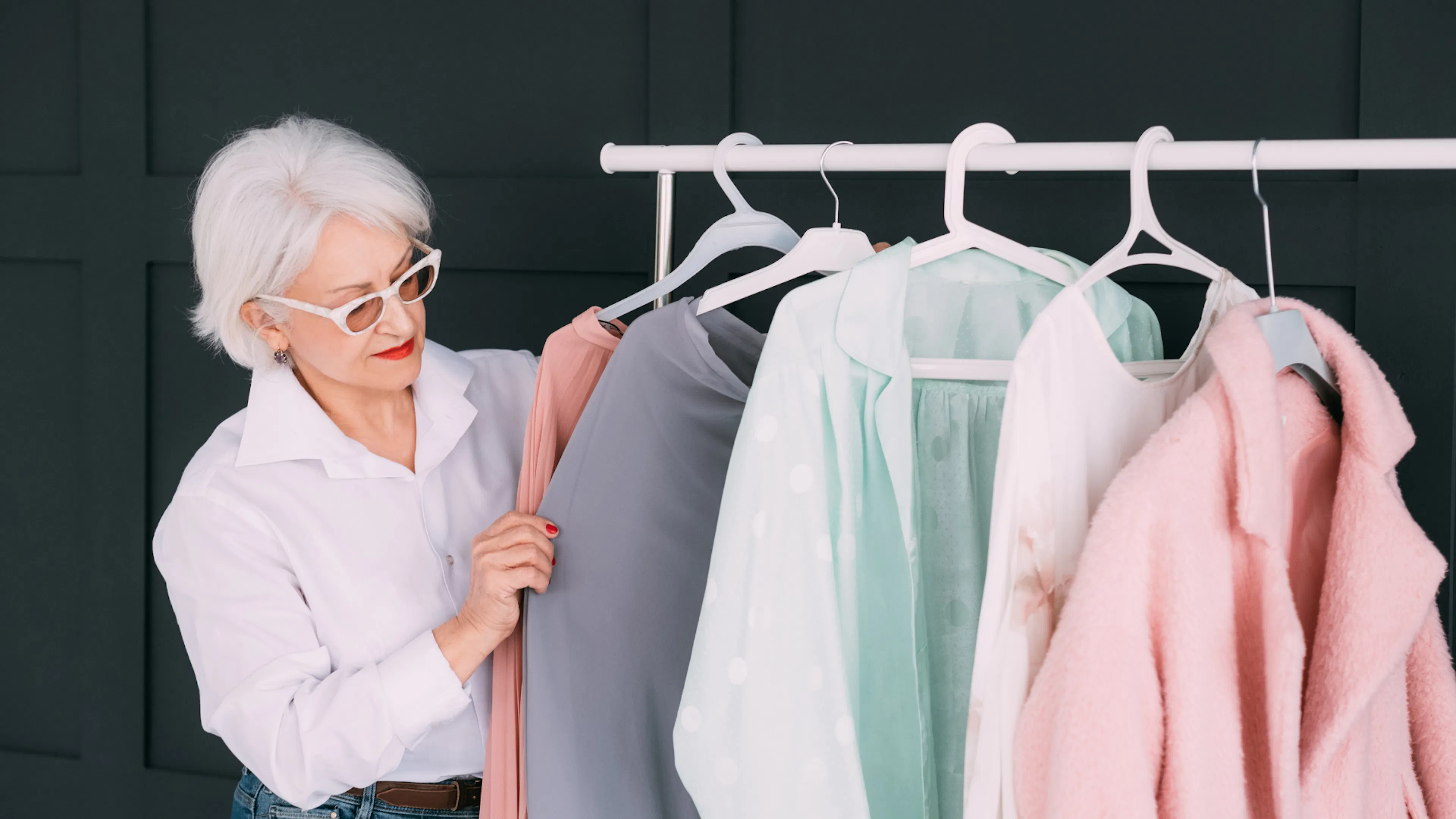 Female retail worker going through a rack of clothes
