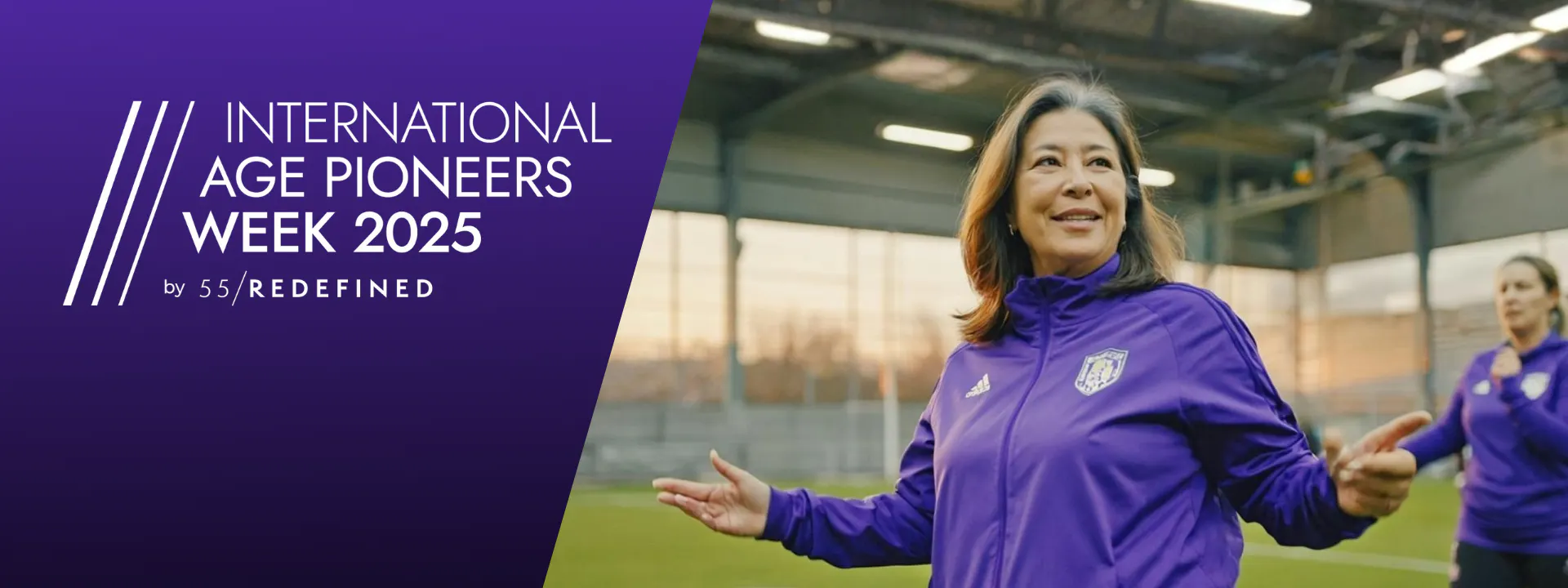 A happy midlife woman standing on a football field.