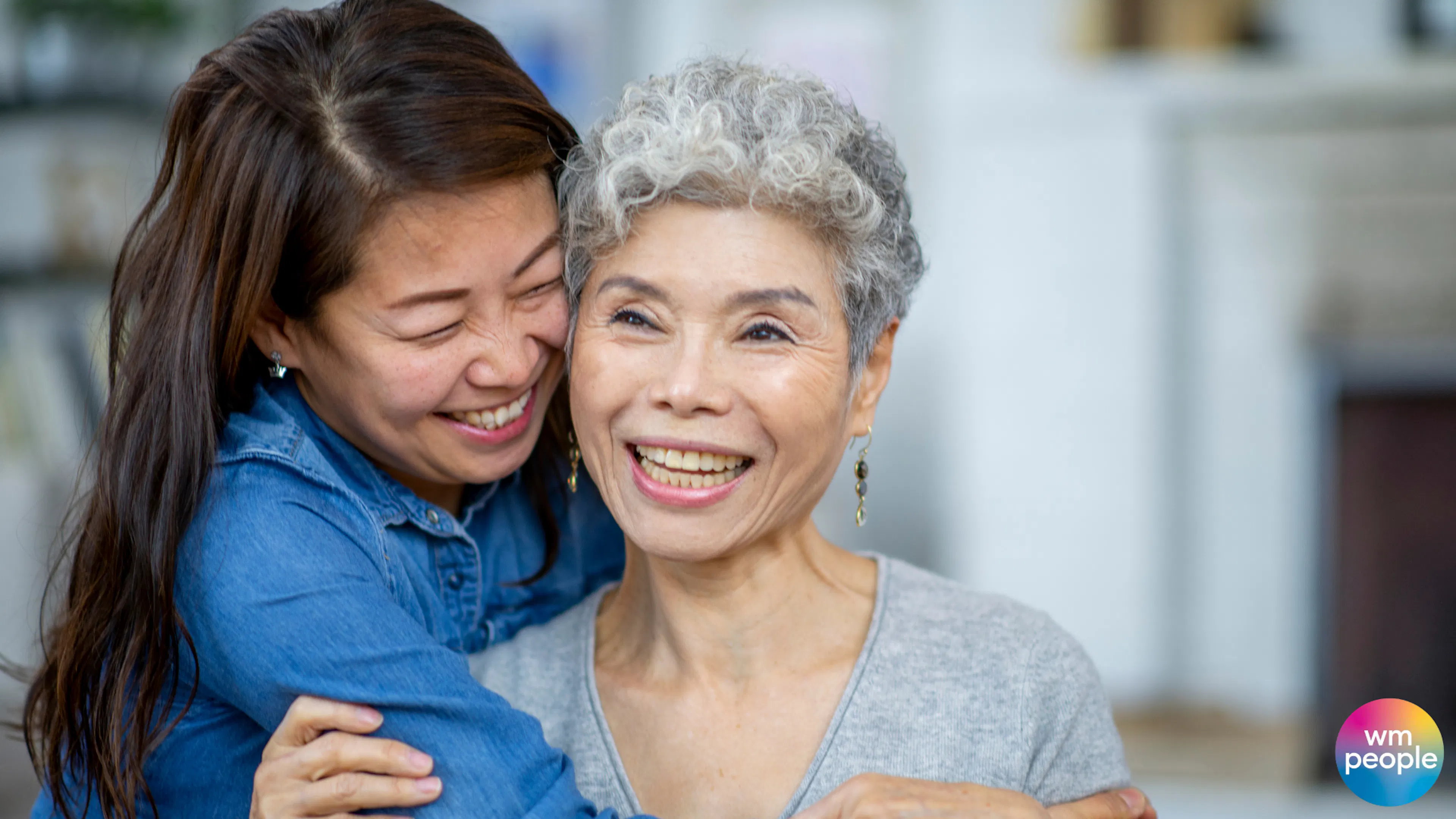Older daughter hugging her mother