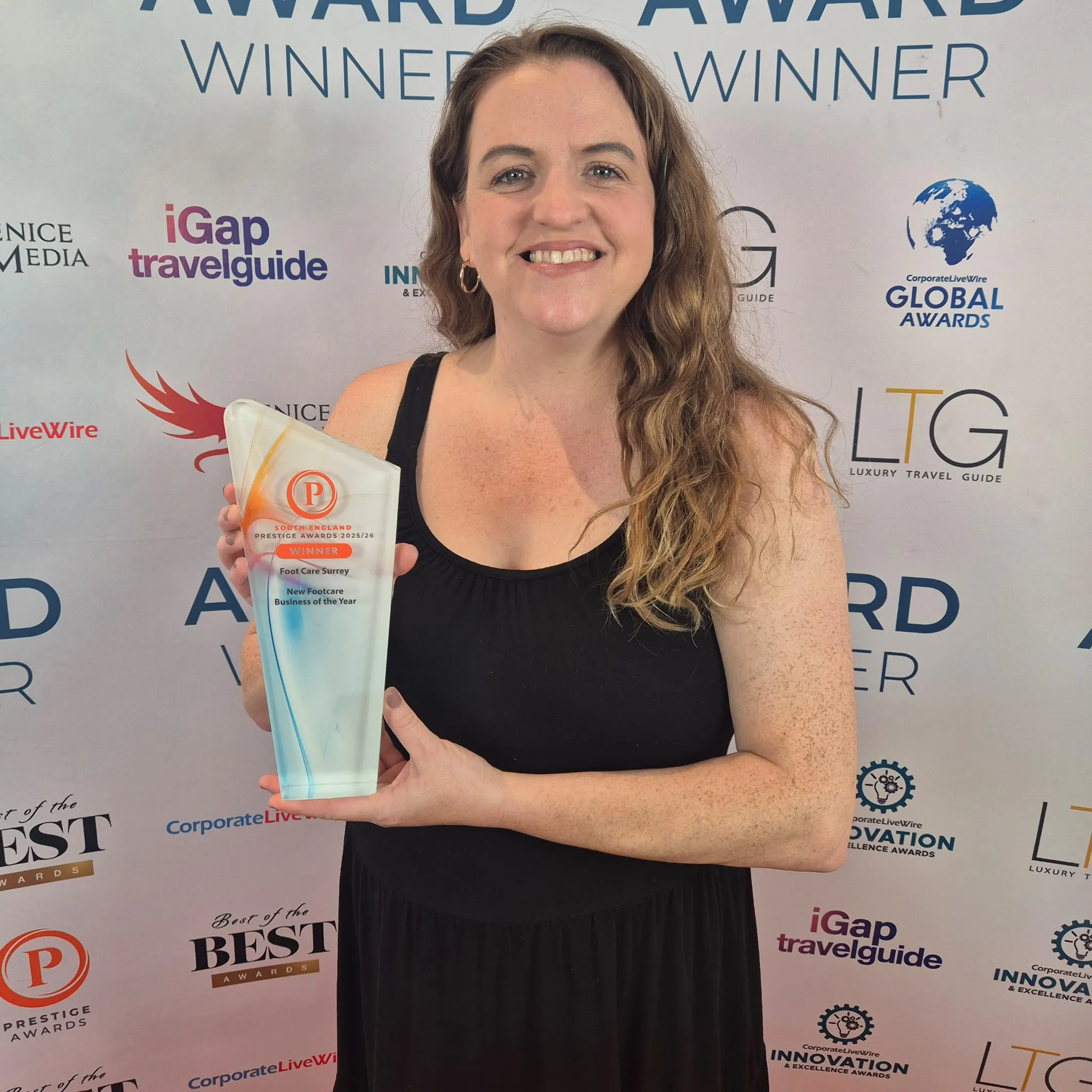 Diane holding the South England Prestige Awards trophy