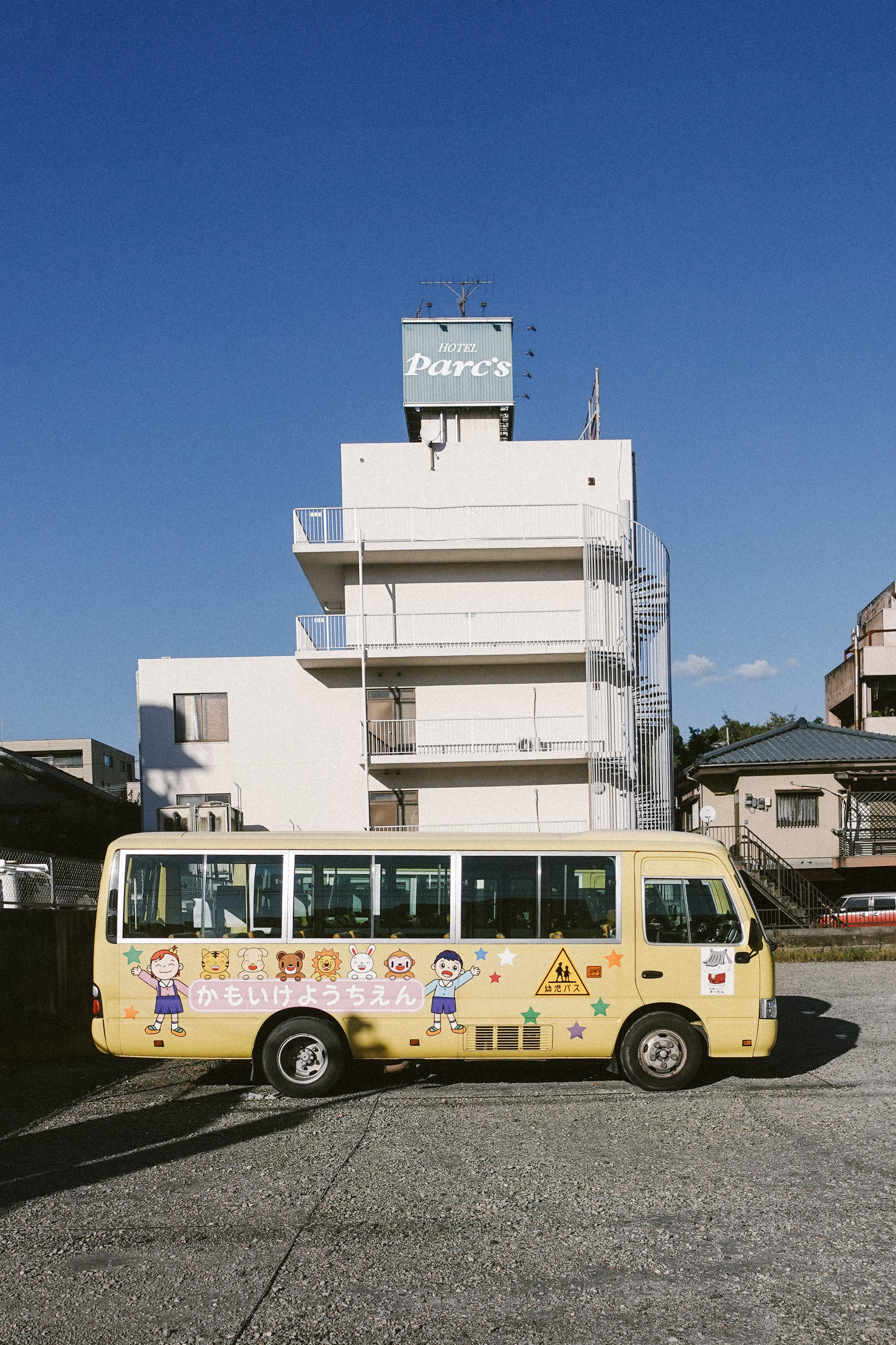 Yellow Japanese kindergarten minibus painted with cartoon animals