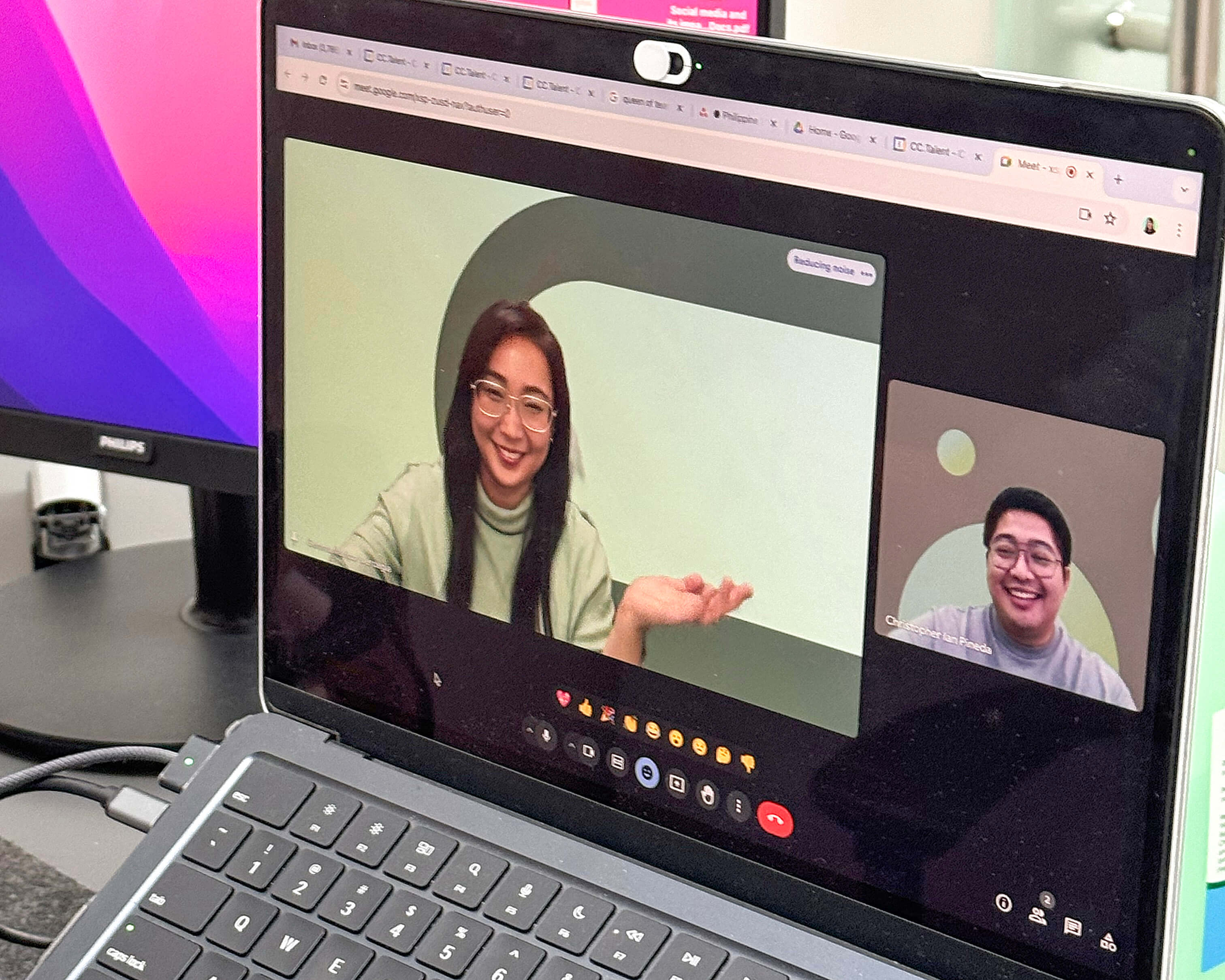 Two colleagues having a video chat through a laptop. 