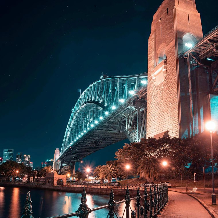 The Sydney Harbour Bridge lit up at night, seen from the North Sydney foreshore