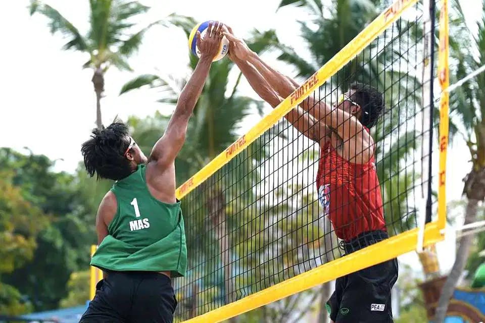 Competitive Volleyball match being played on Sentosa's beachfront coastline