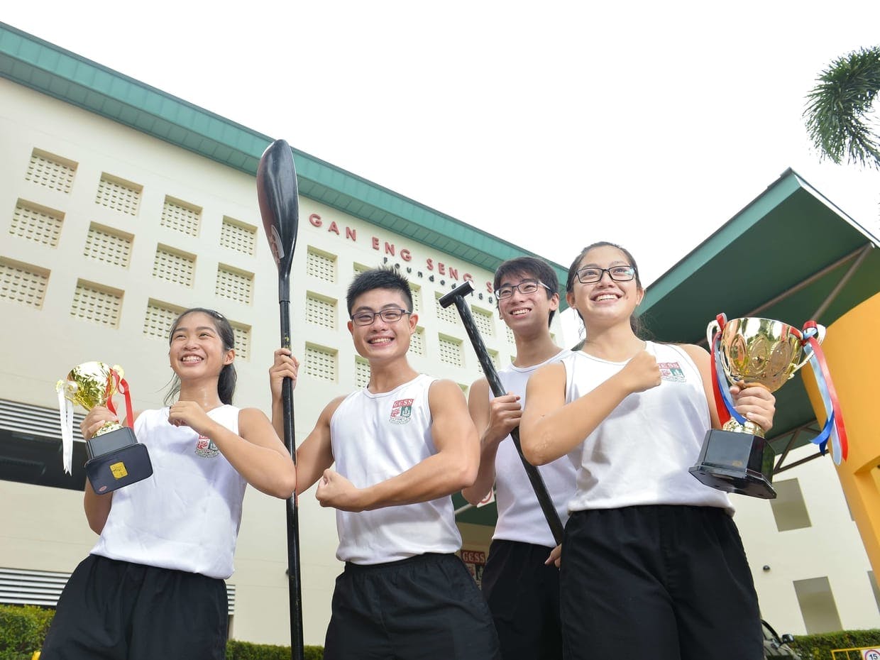 Students of Gan Eng Seng School holding throphies
