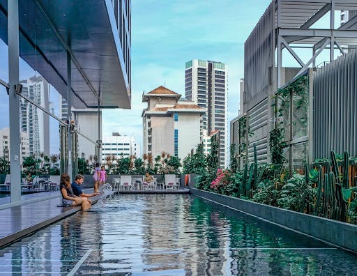 A cool sparkling turquoise pool surrounded by a cactus garden and expansive glass windows allow for elegant family time at Gems Ville.