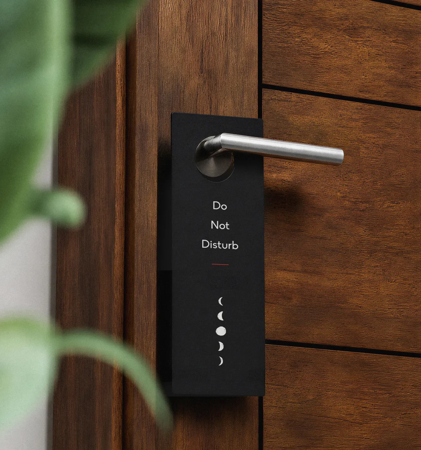 Do Not Disturb door hanger on a wooden door