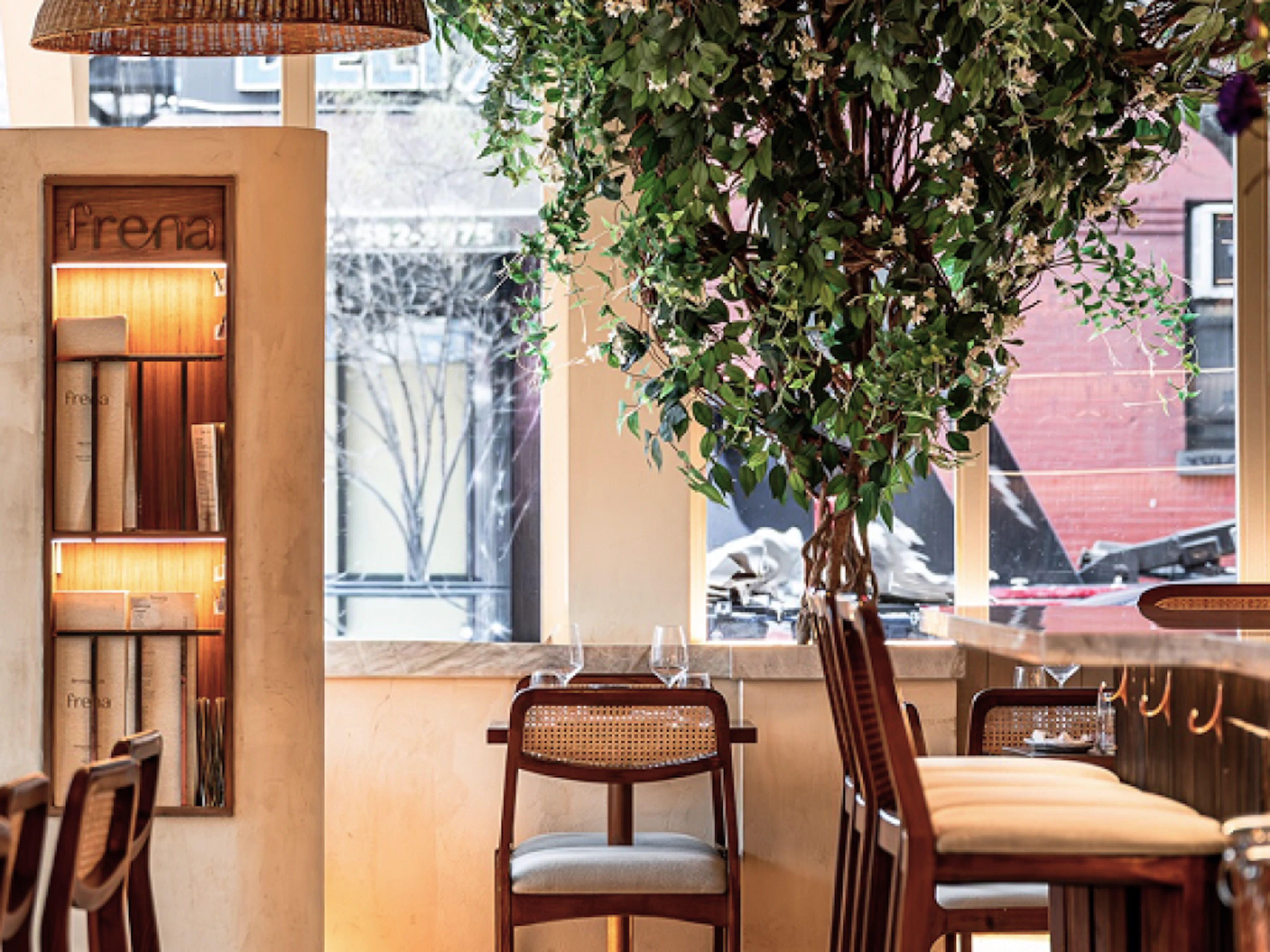 Frena restaurant interior with rattan pendant lights and greenery
