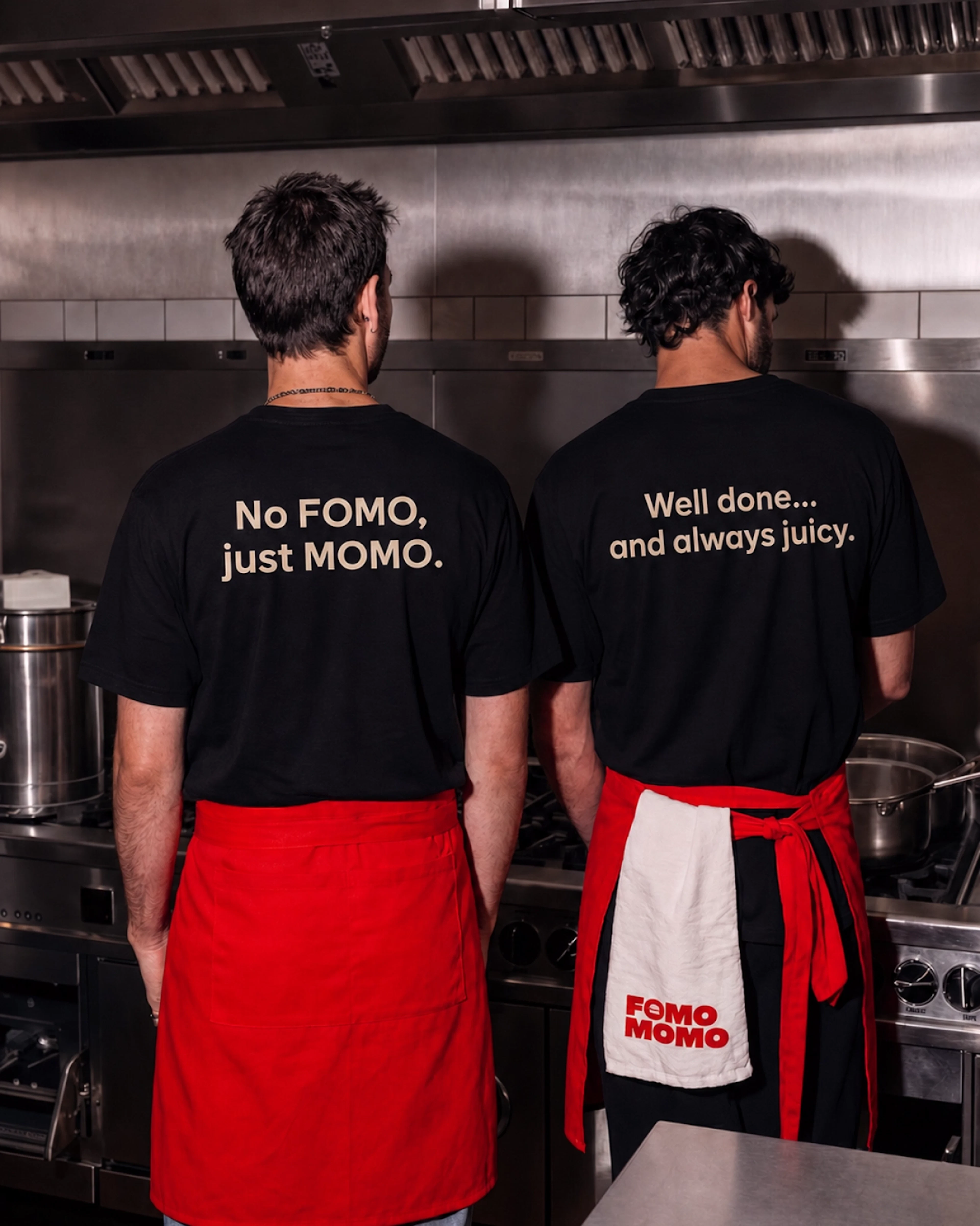 Two chefs from behind wearing No FOMO just MOMO t-shirts