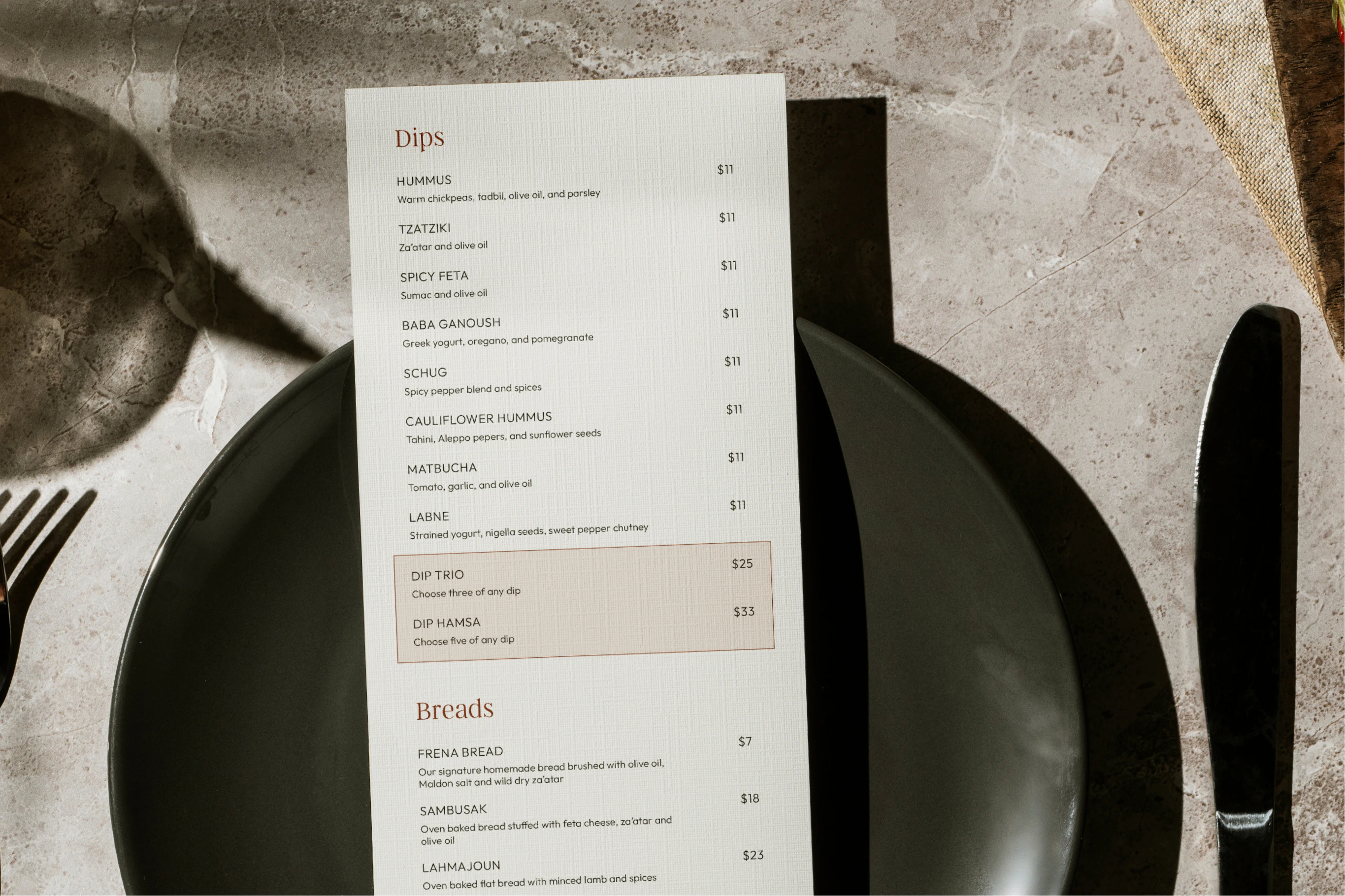 Frena dips menu on a table setting with black plates