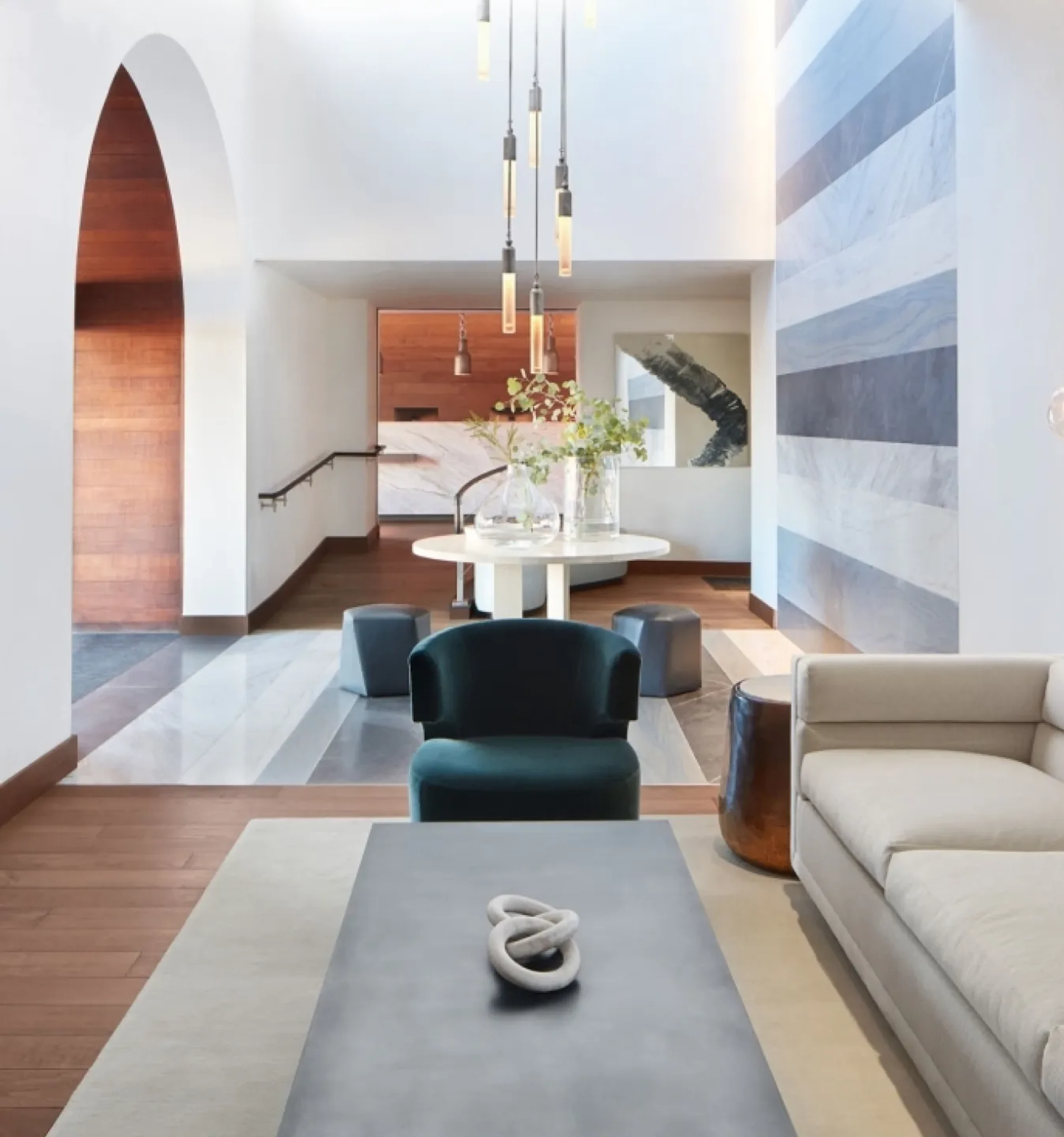Lobby lounge with arched doorway and teal armchair