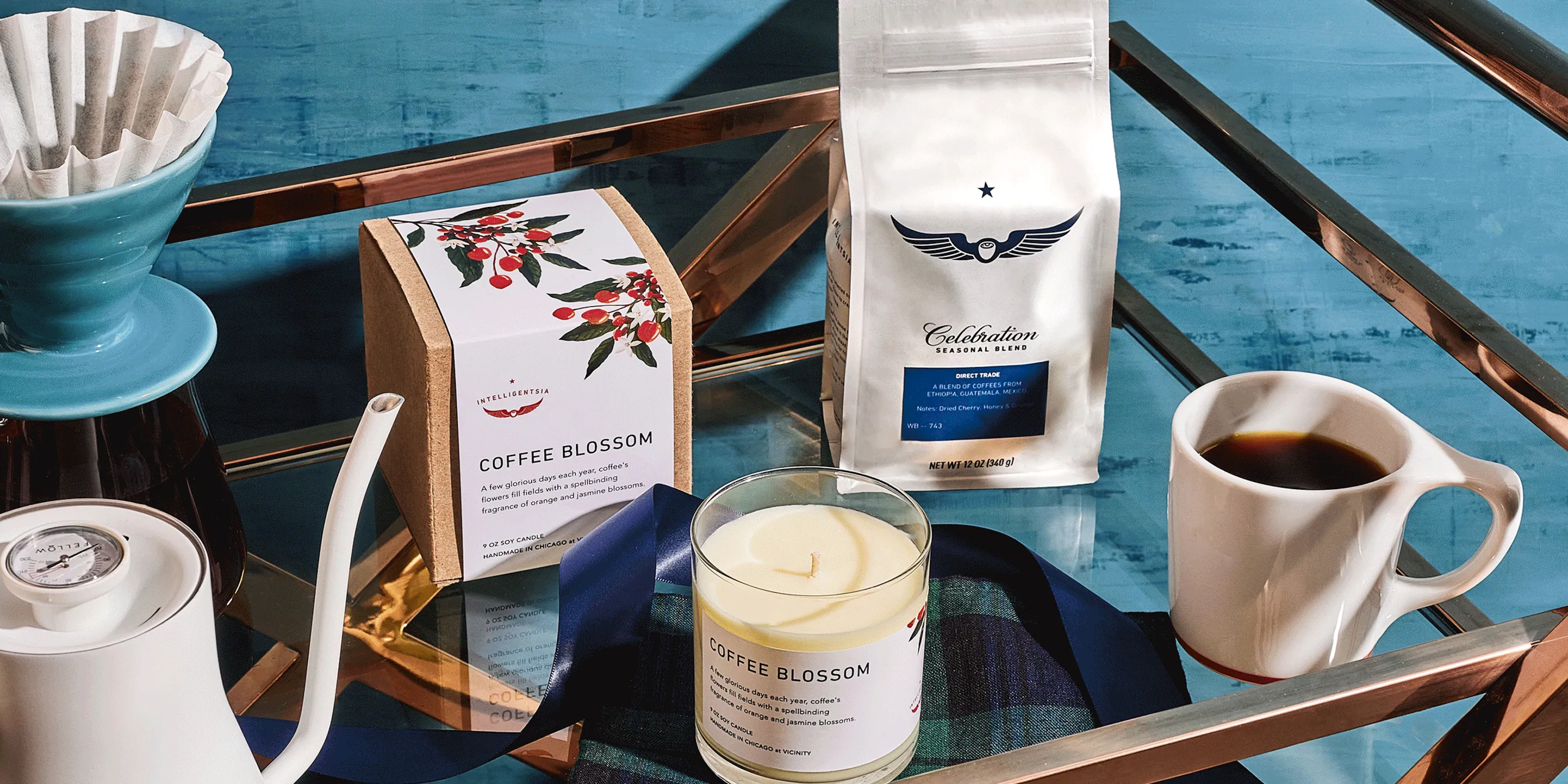 Coffee Blossom candle, coffee bag and pour-over kit on a teal cart