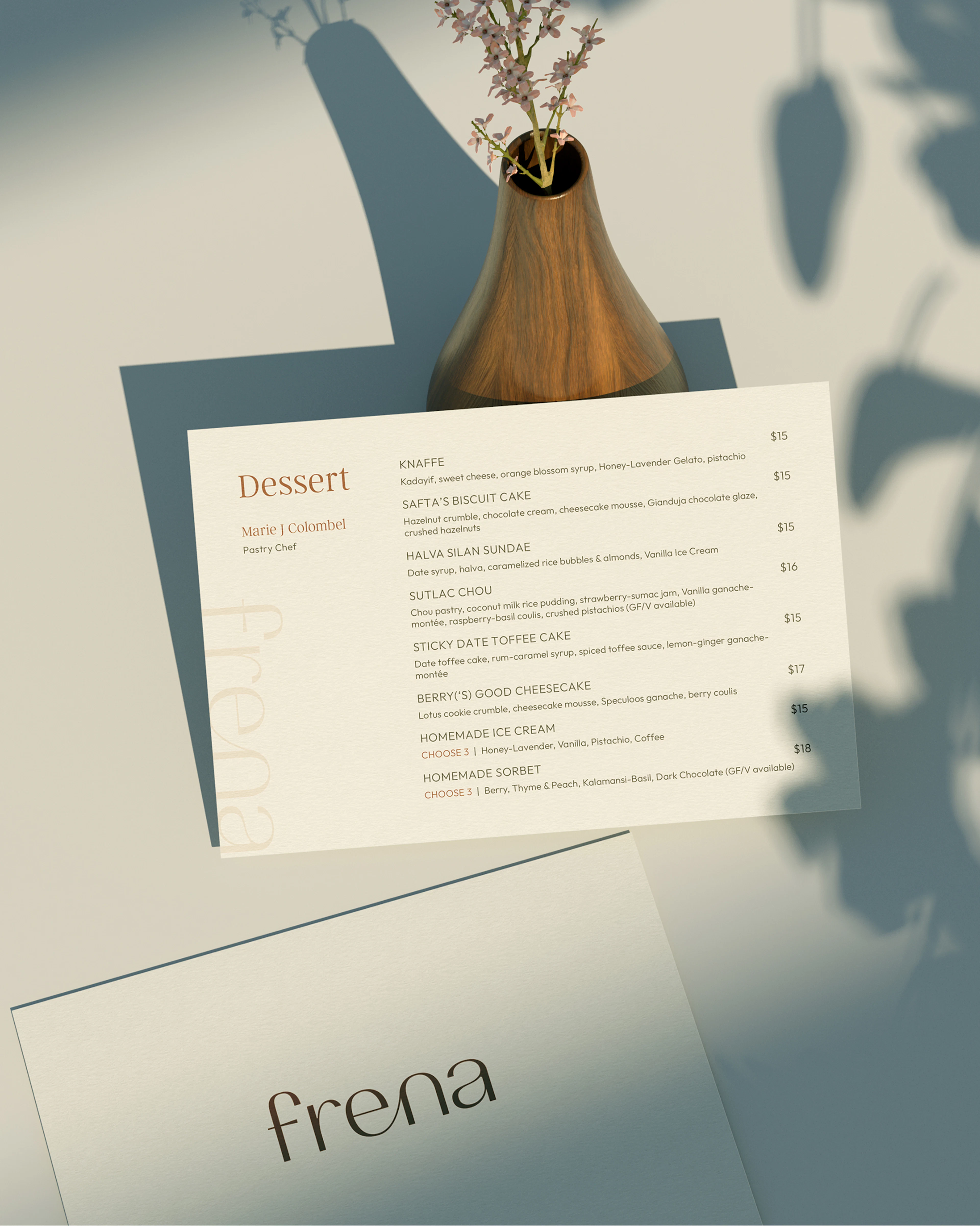 Frena dessert menu beside a small vase of flowers