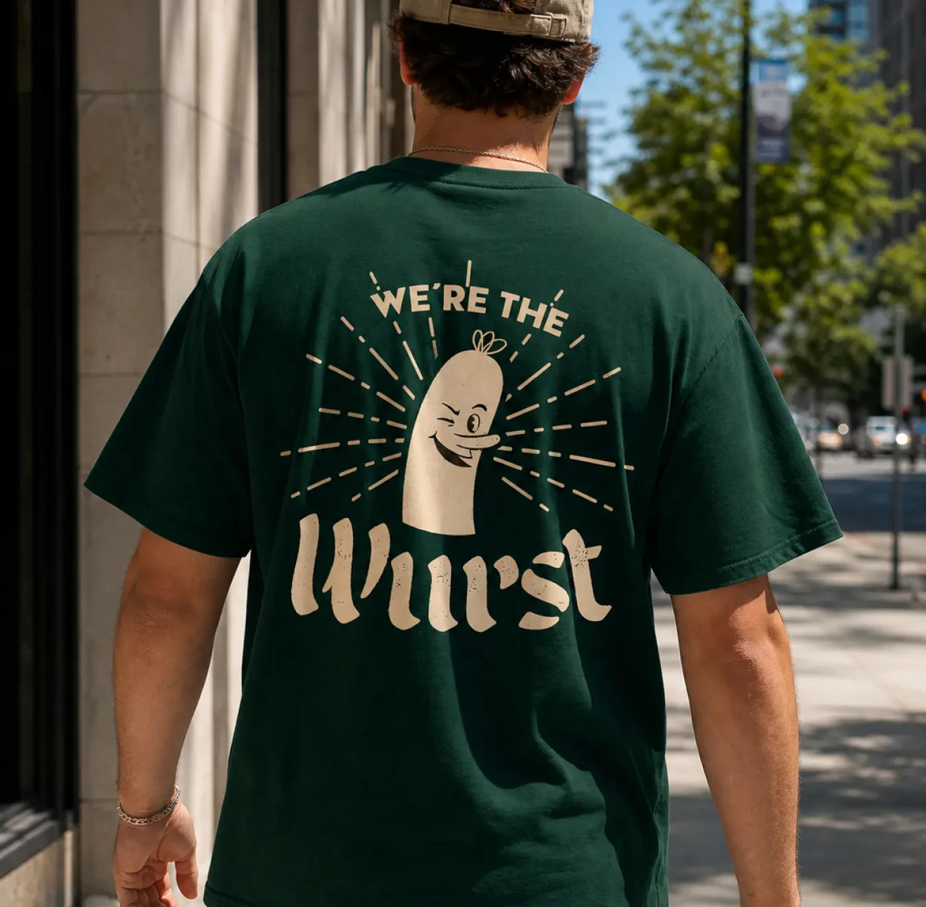 Man wearing a green Schaller's Stube 'We're The Wurst' t-shirt
