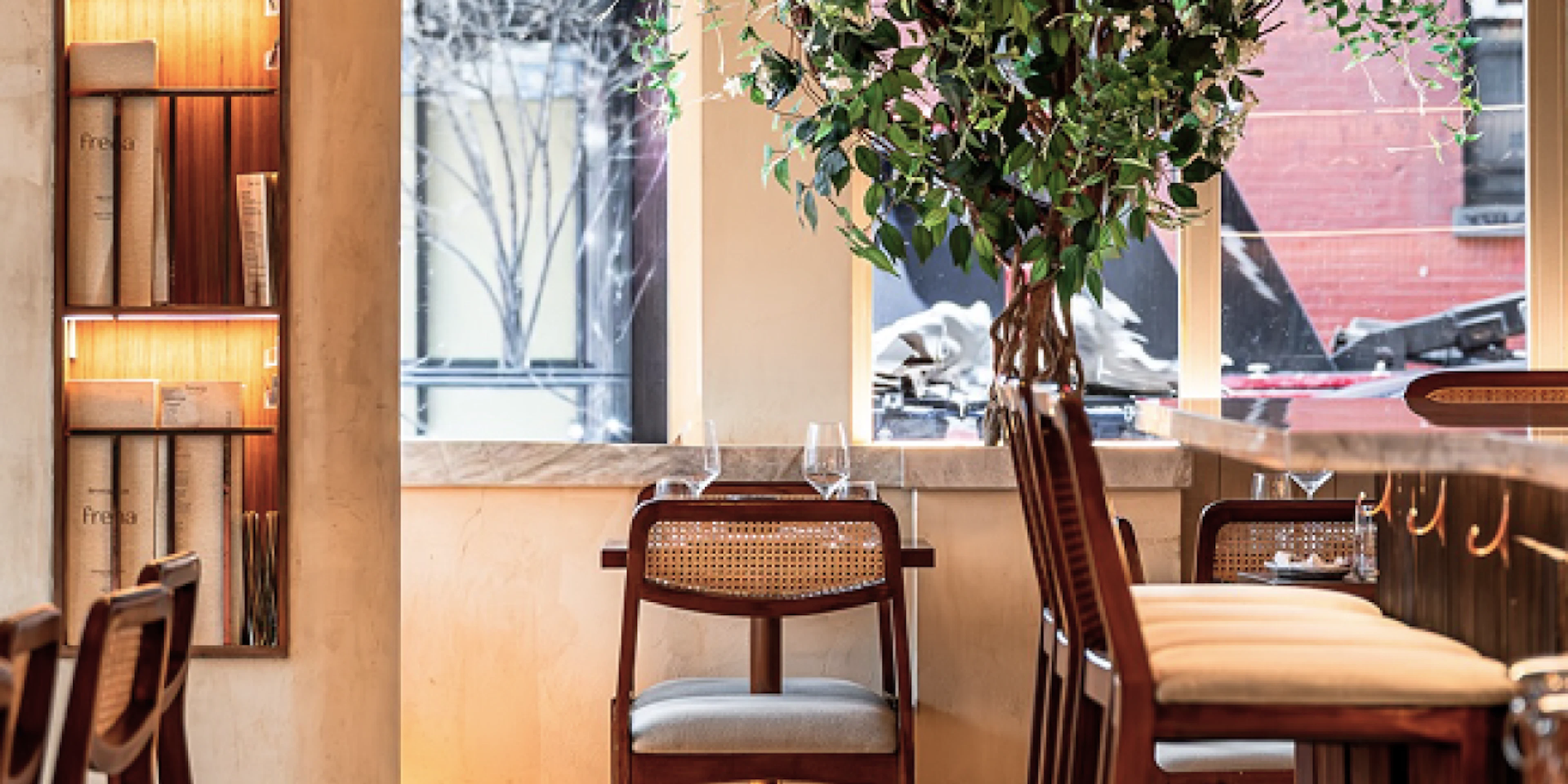 Frena restaurant interior with rattan pendant lights and greenery