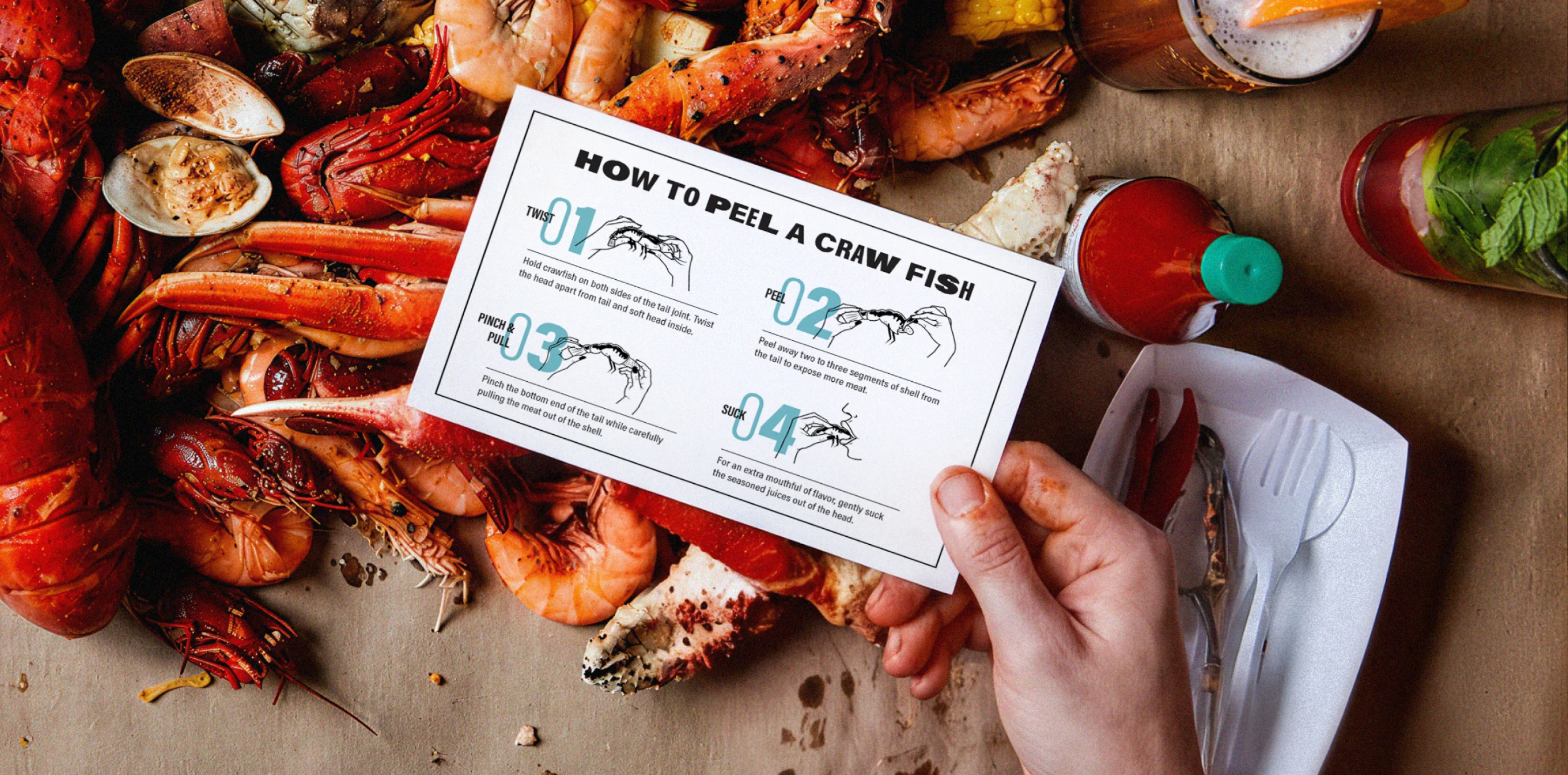 Crawfish peeling instruction card held over a seafood spread