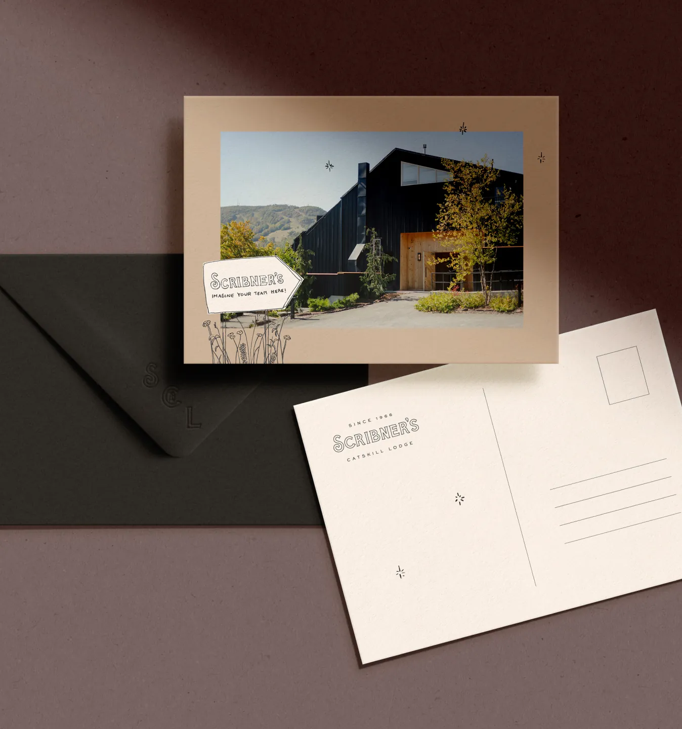 Scribner's postcard with lodge photo beside envelope