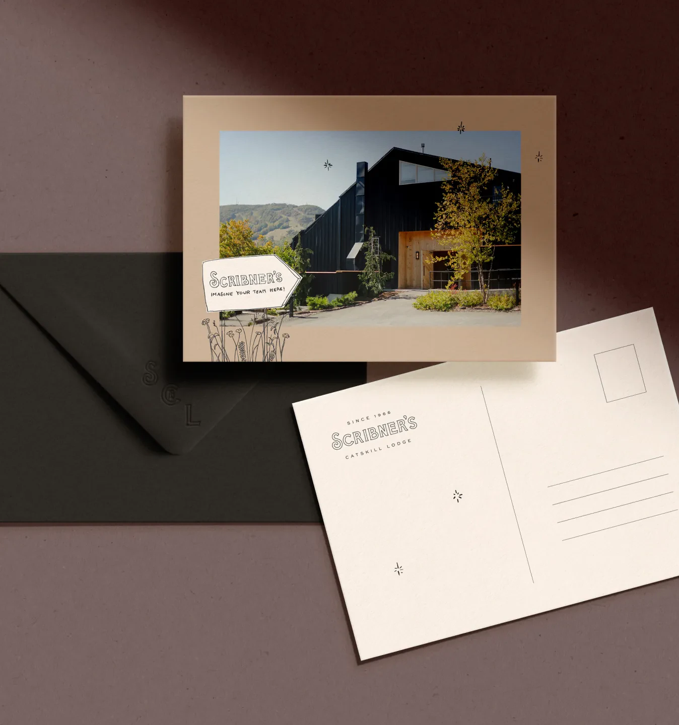 Scribner's postcard with lodge photo beside envelope