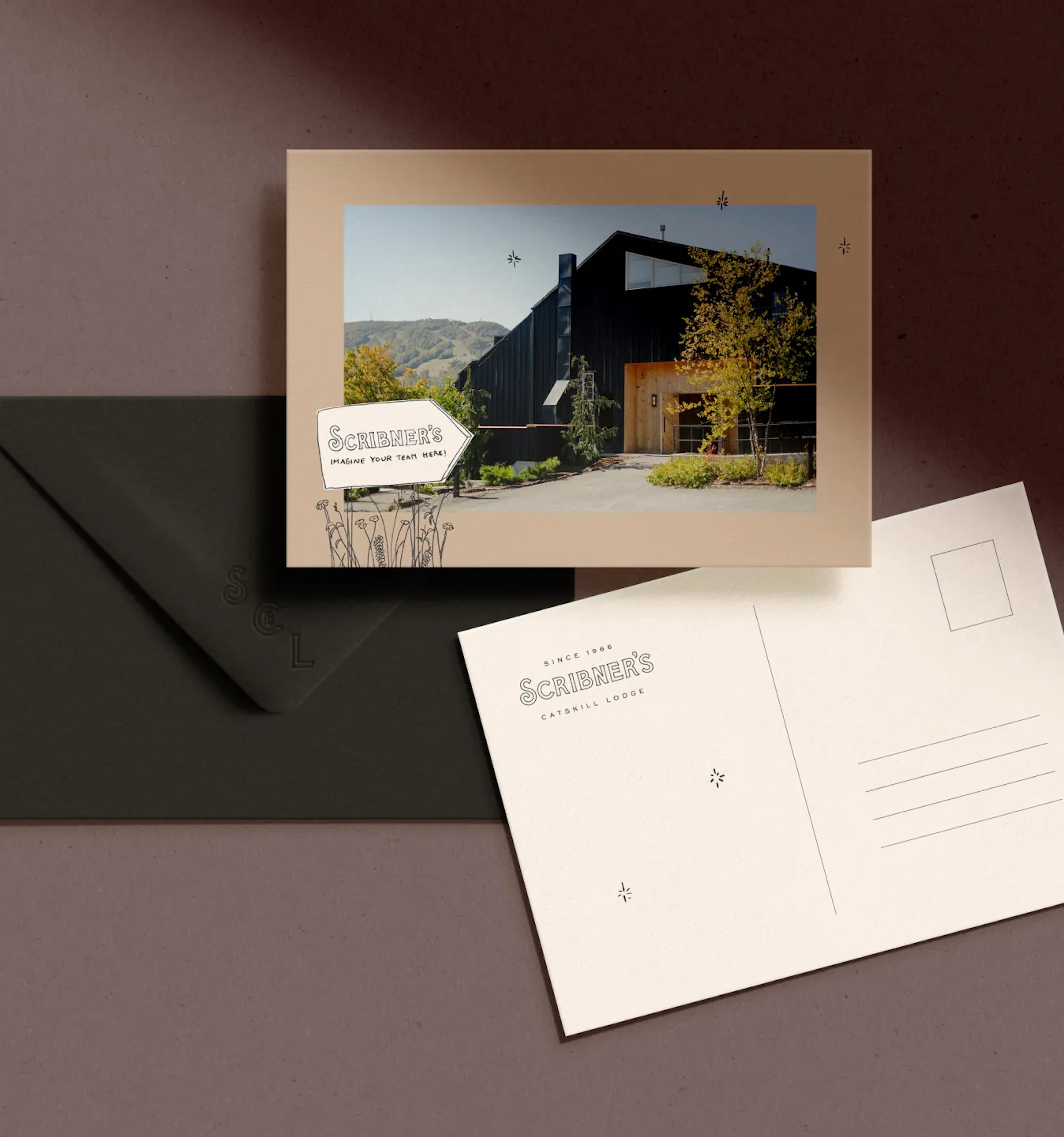 Scribner's postcard with lodge photo beside envelope