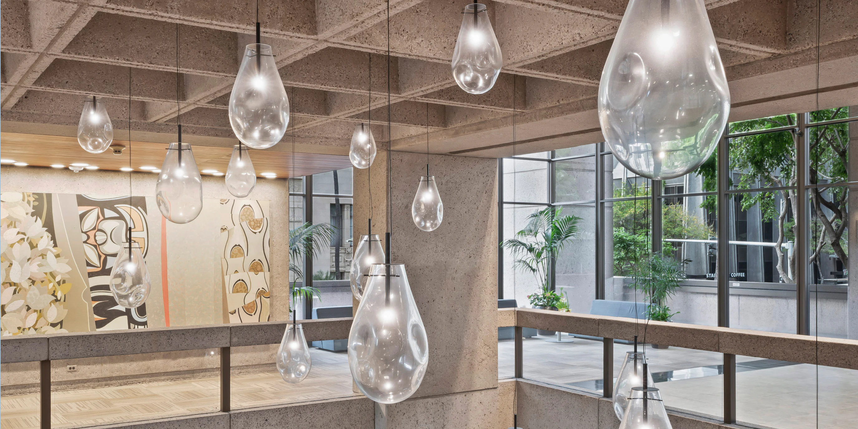 Hand-blown glass pendants float beneath the original concrete waffle slab in Modea's garden-level lobby.