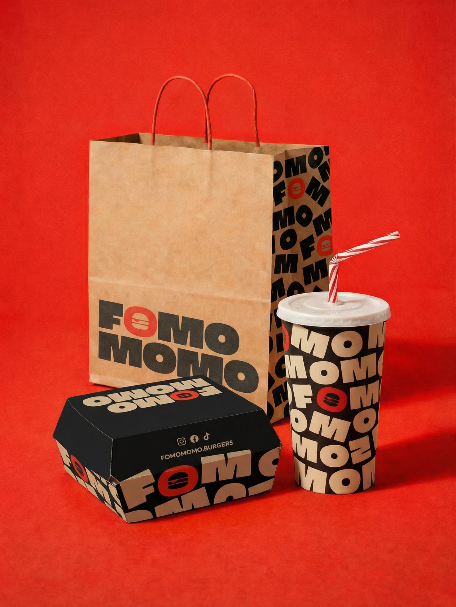 Take out food containers like a brown paper bag, cardboard burger box and drink that have the branding for Fomo Momo printing
