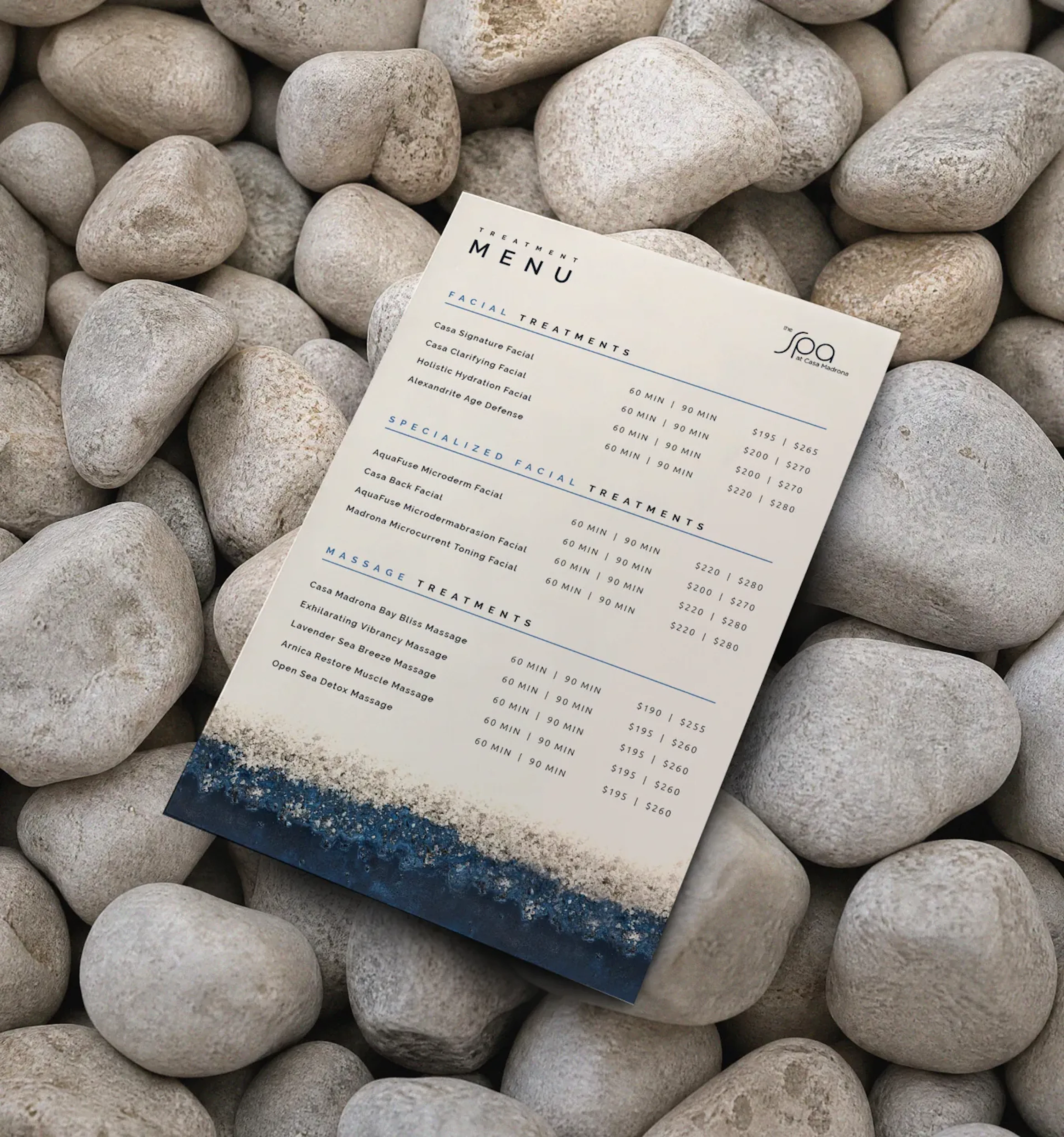 Spa treatment menu card on white stones