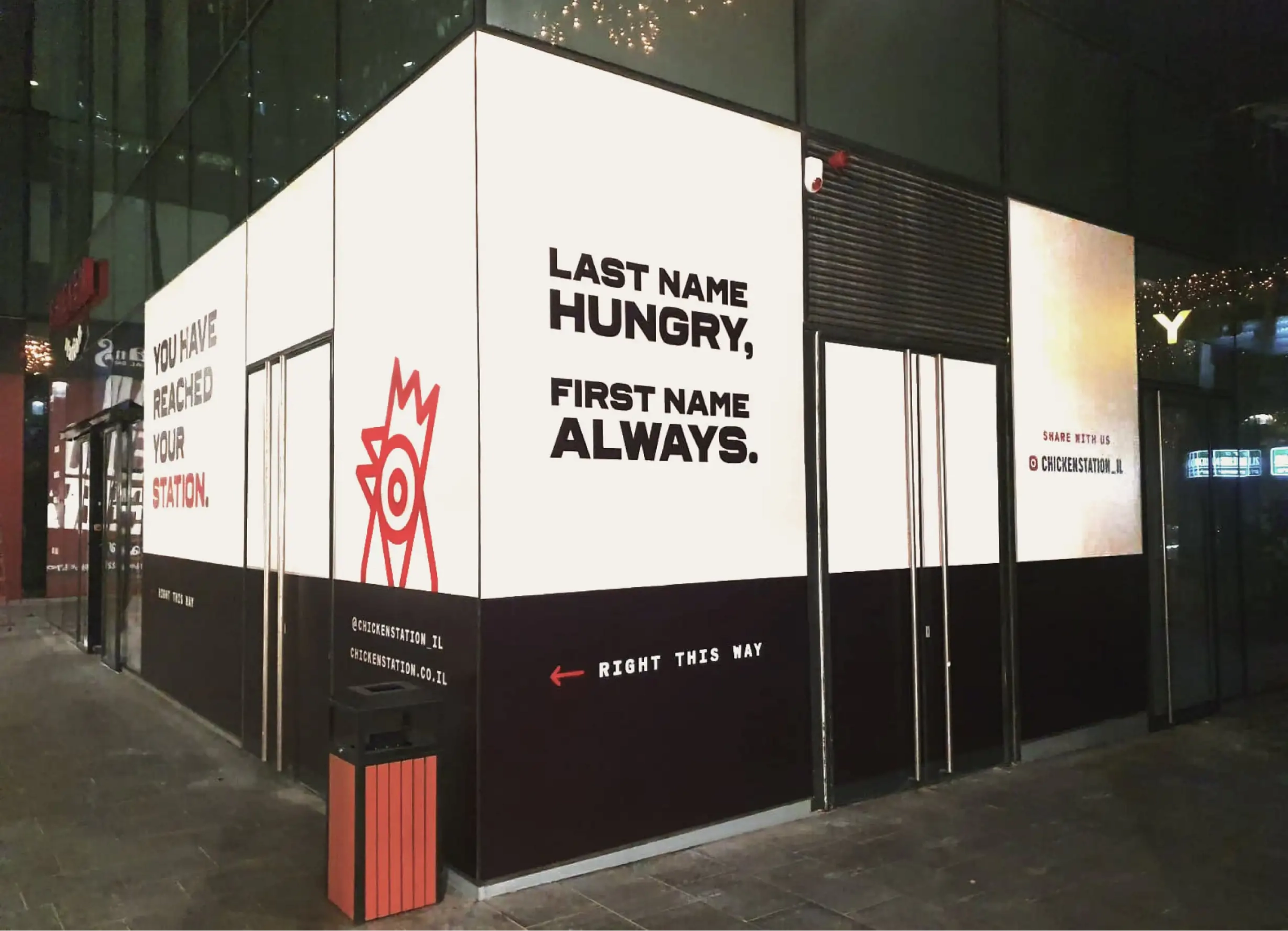 Chicken Station storefront signage lit up at night